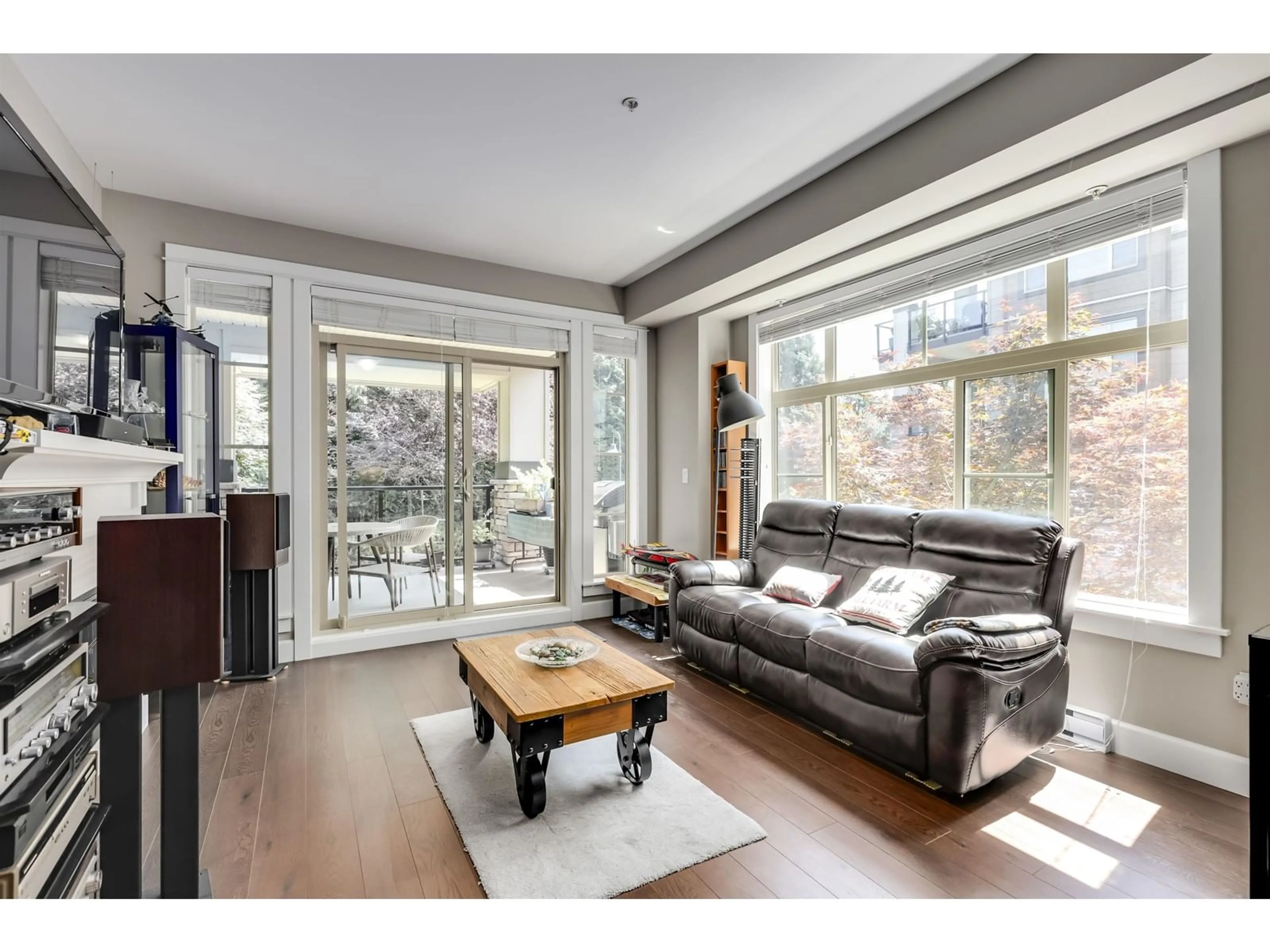 Living room with furniture, wood/laminate floor for 205 - 15185 36, Surrey British Columbia V3Z4R3