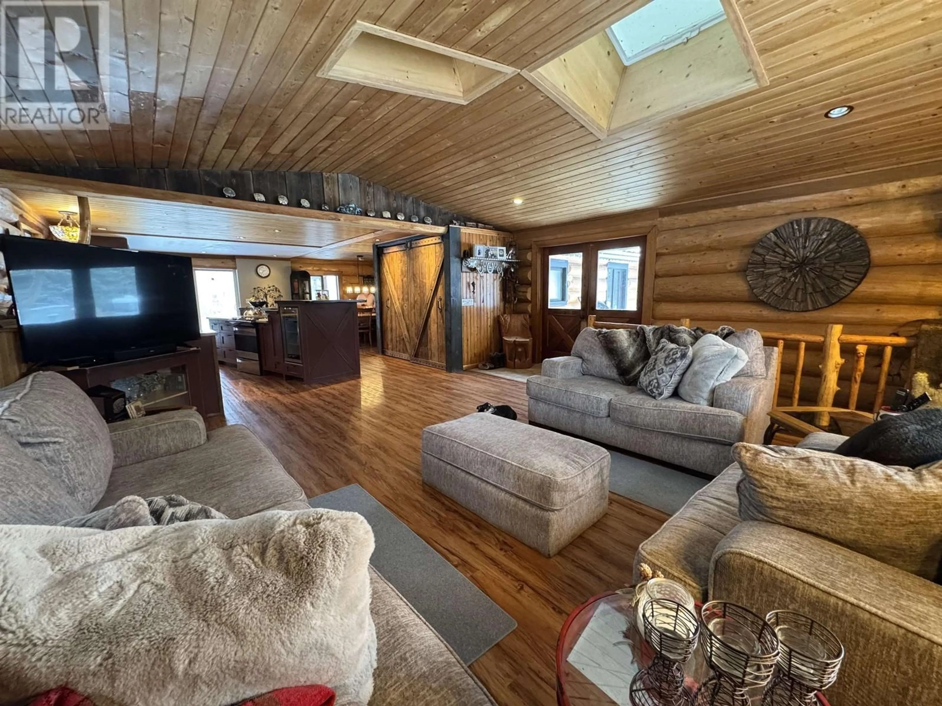 Living room with furniture, wood/laminate floor for 409 PHEASANT DRIVE, Williams Lake British Columbia V2G5A9