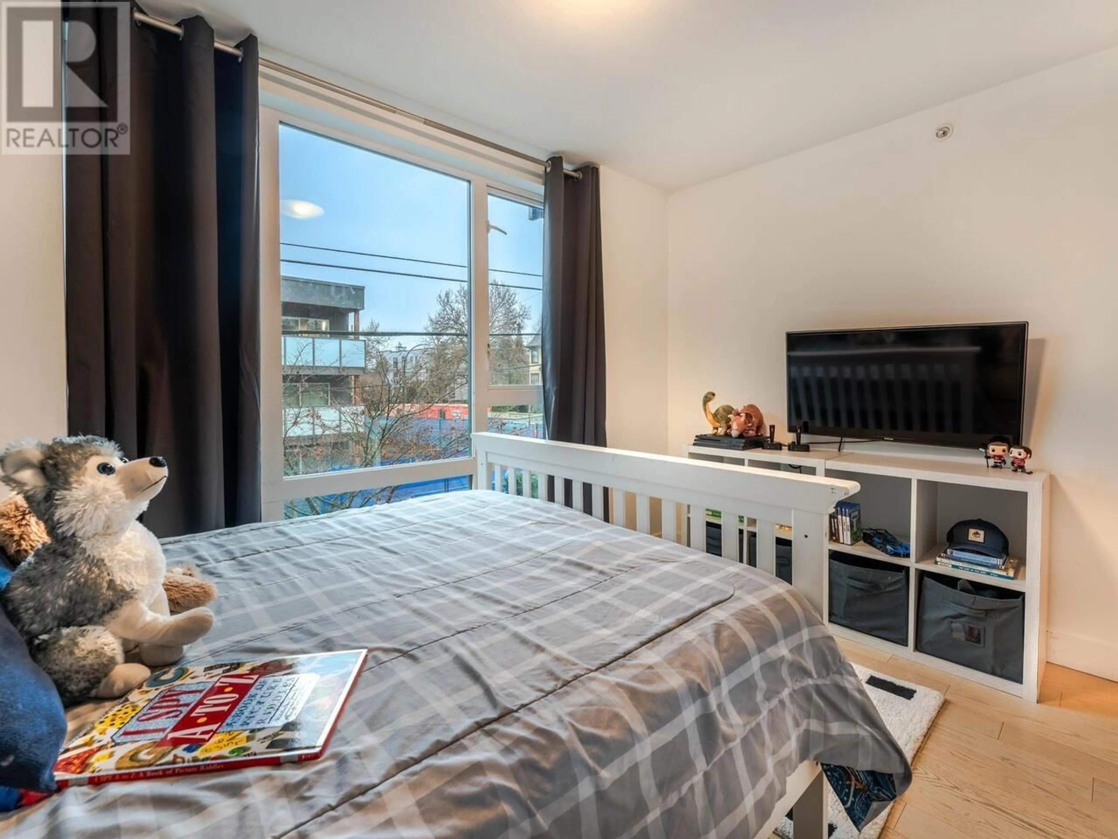 Bedroom with bed, wood/laminate floor for 101 2477 CAROLINA STREET, Vancouver British Columbia V5T0G8