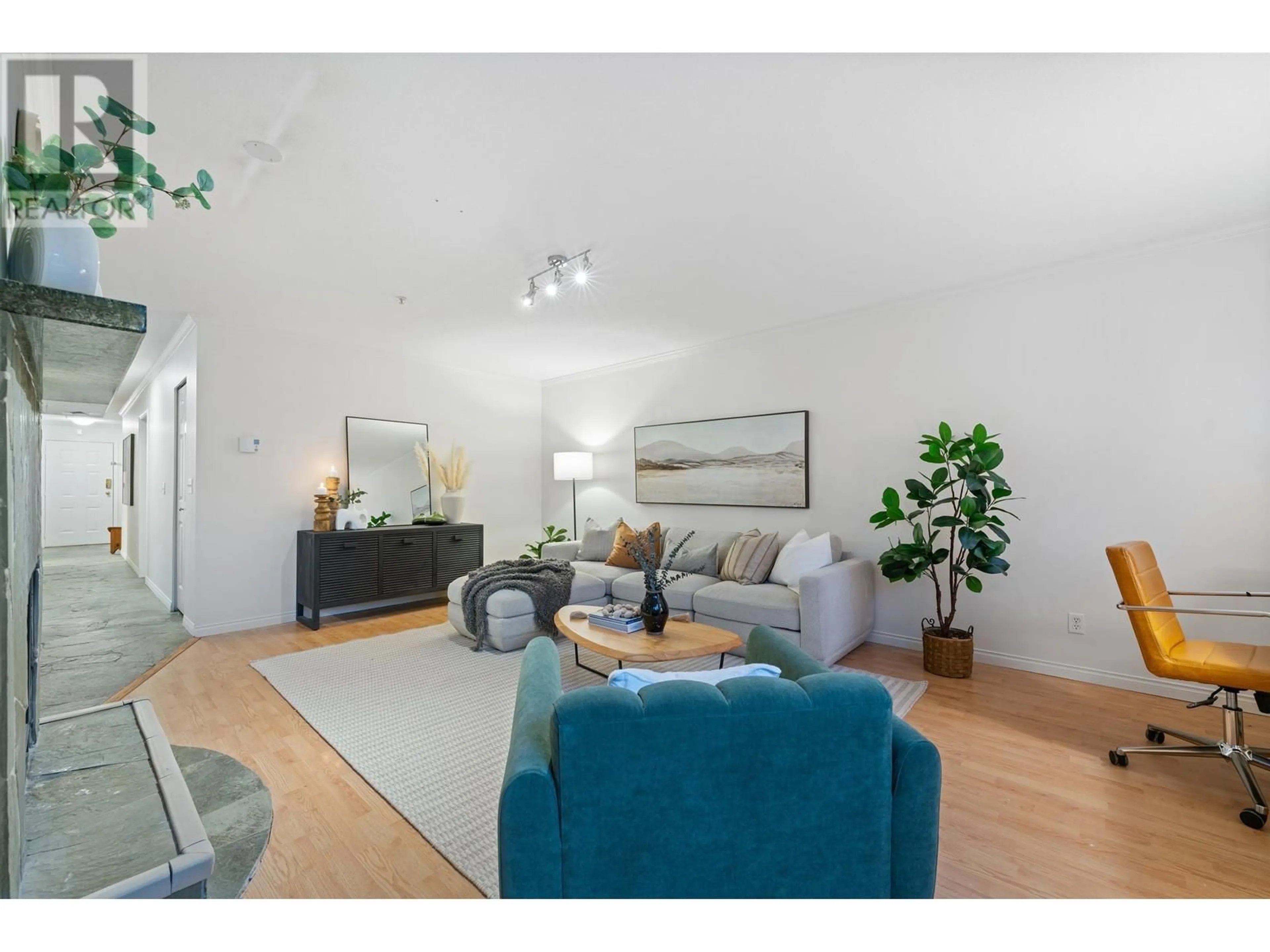 Living room with furniture, wood/laminate floor for 309 1050 BOWRON COURT, North Vancouver British Columbia V7H2X6