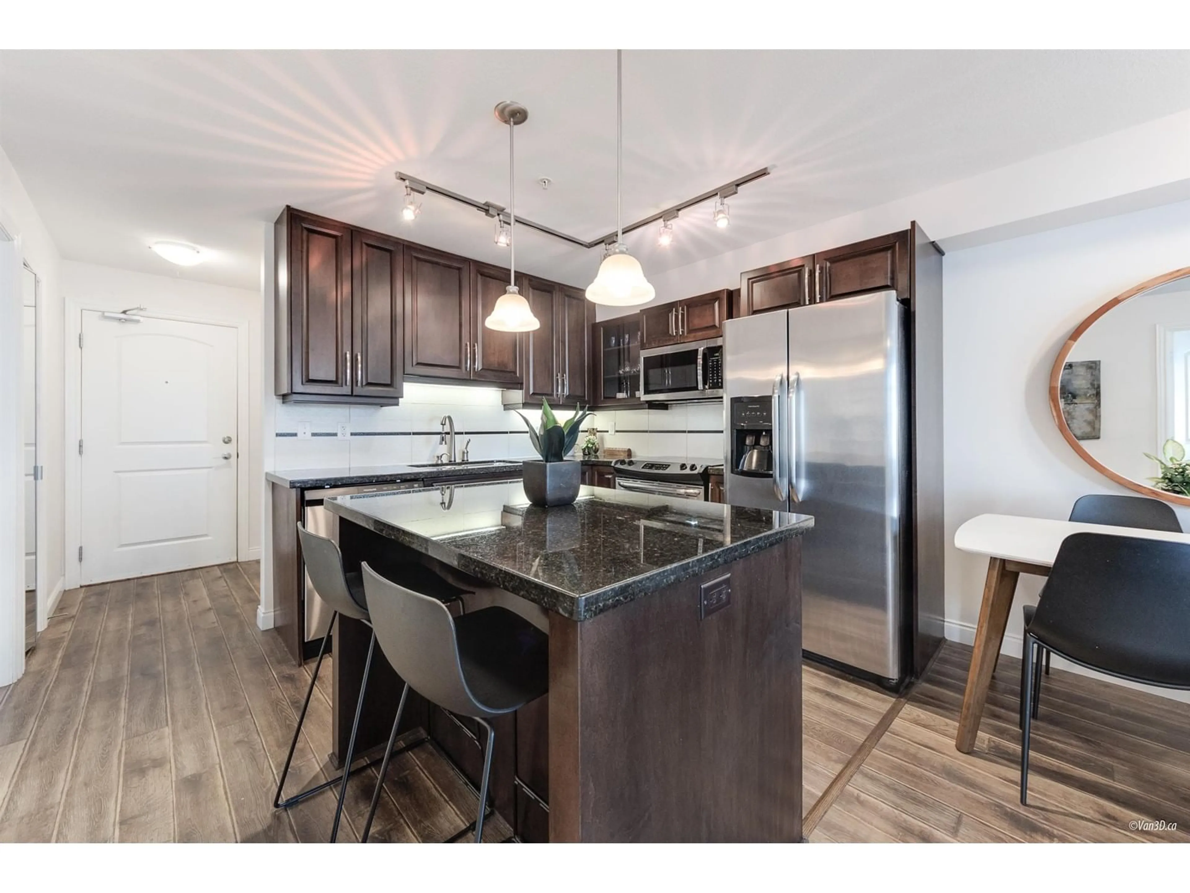 Open concept kitchen, wood/laminate floor for 211 - 19939 55A, Langley British Columbia V3A3X4