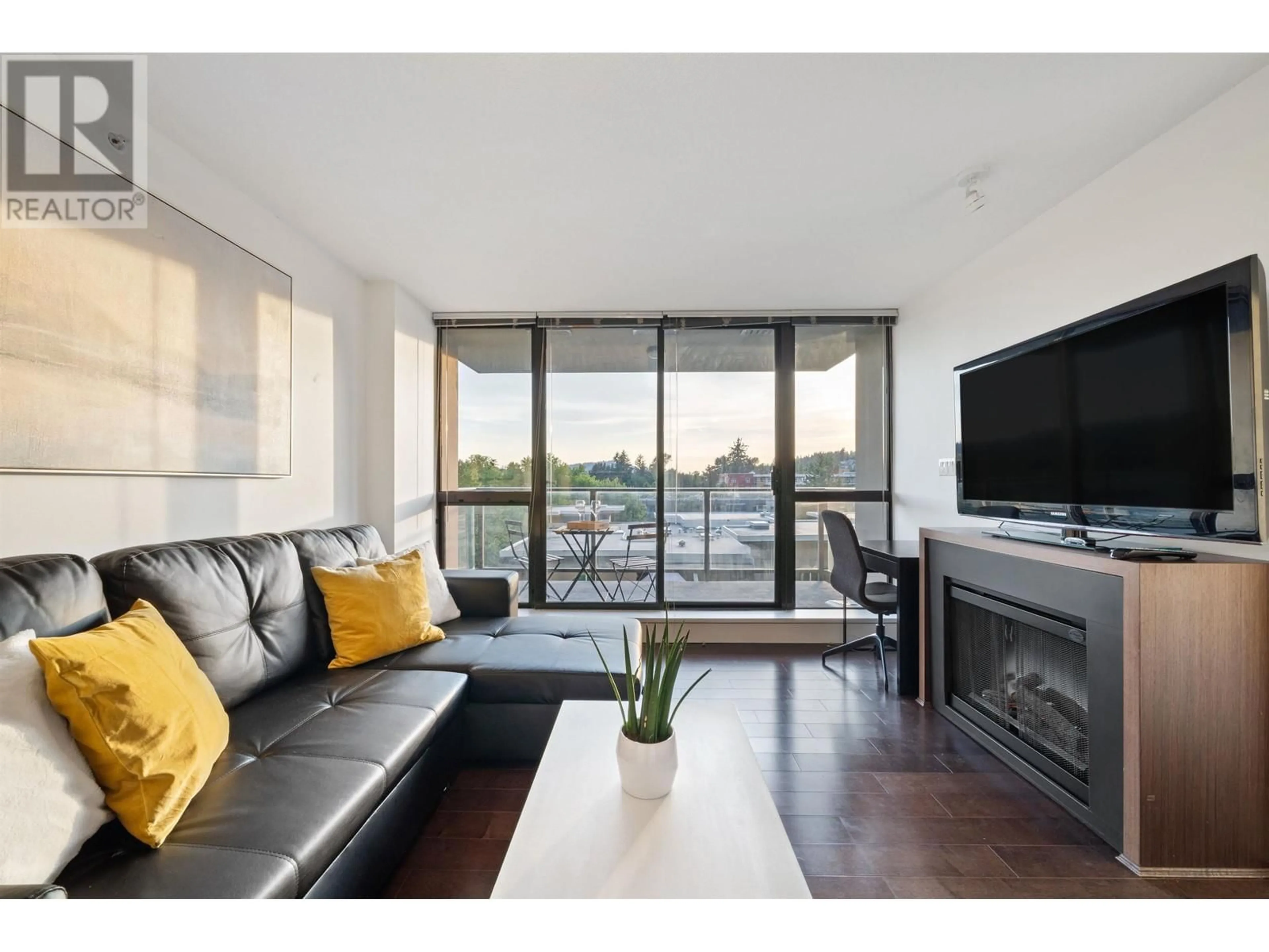 Living room with furniture, wood/laminate floor for 706 2959 GLEN DRIVE, Coquitlam British Columbia V3B0B8