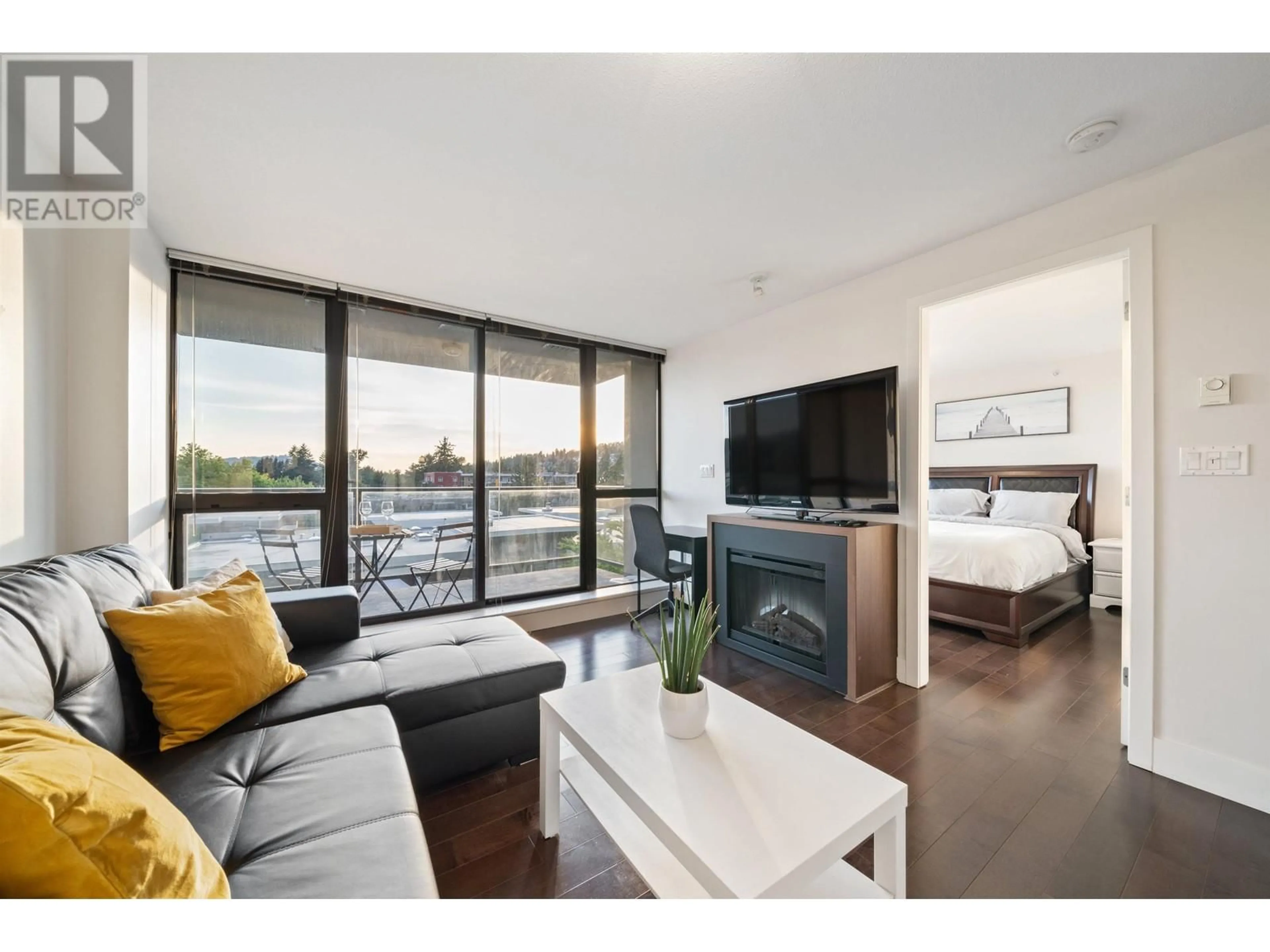 Living room with furniture, wood/laminate floor for 706 2959 GLEN DRIVE, Coquitlam British Columbia V3B0B8