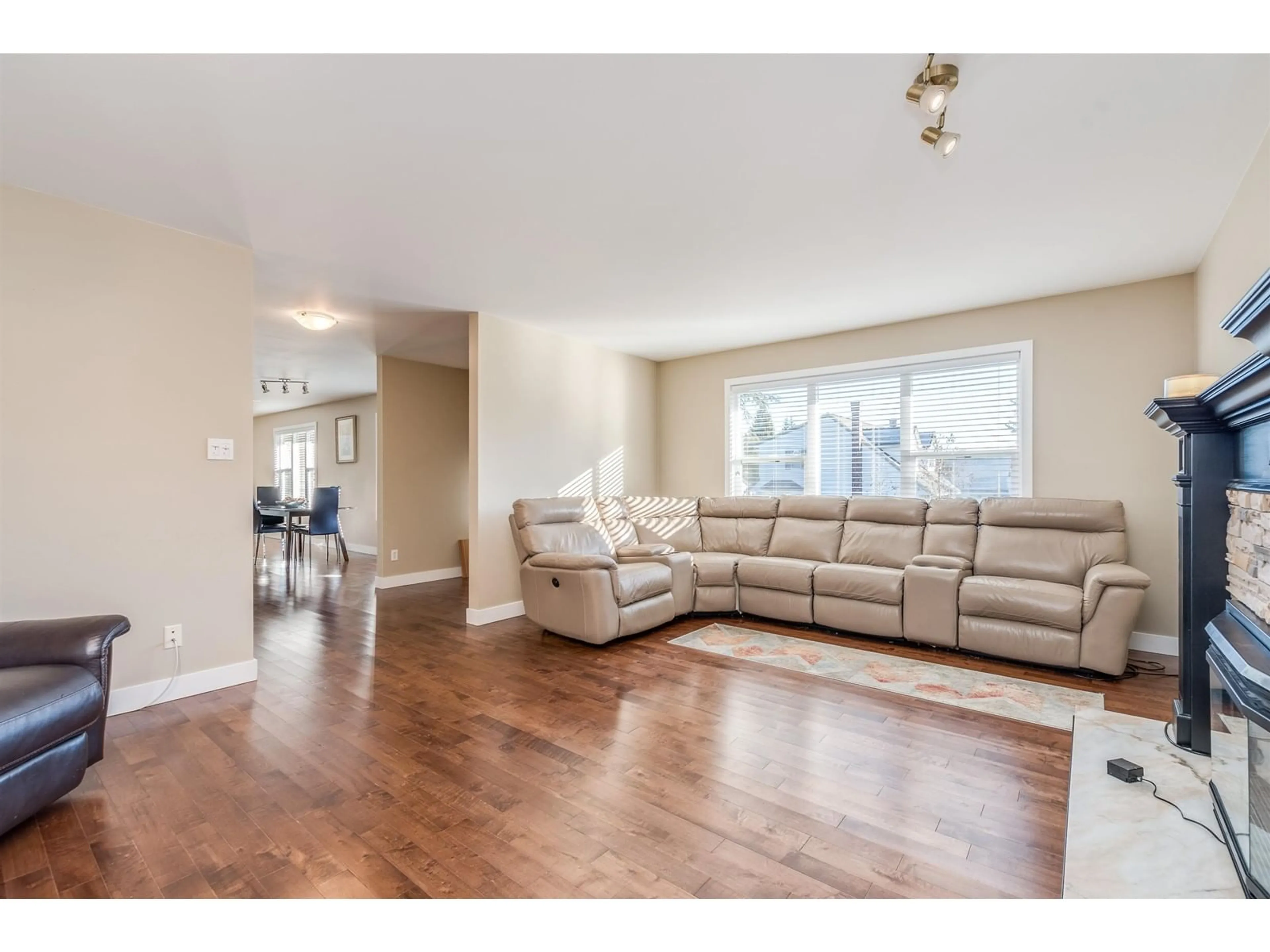 Living room with furniture, wood/laminate floor for 15825 101 AVENUE, Surrey British Columbia V4N2S6