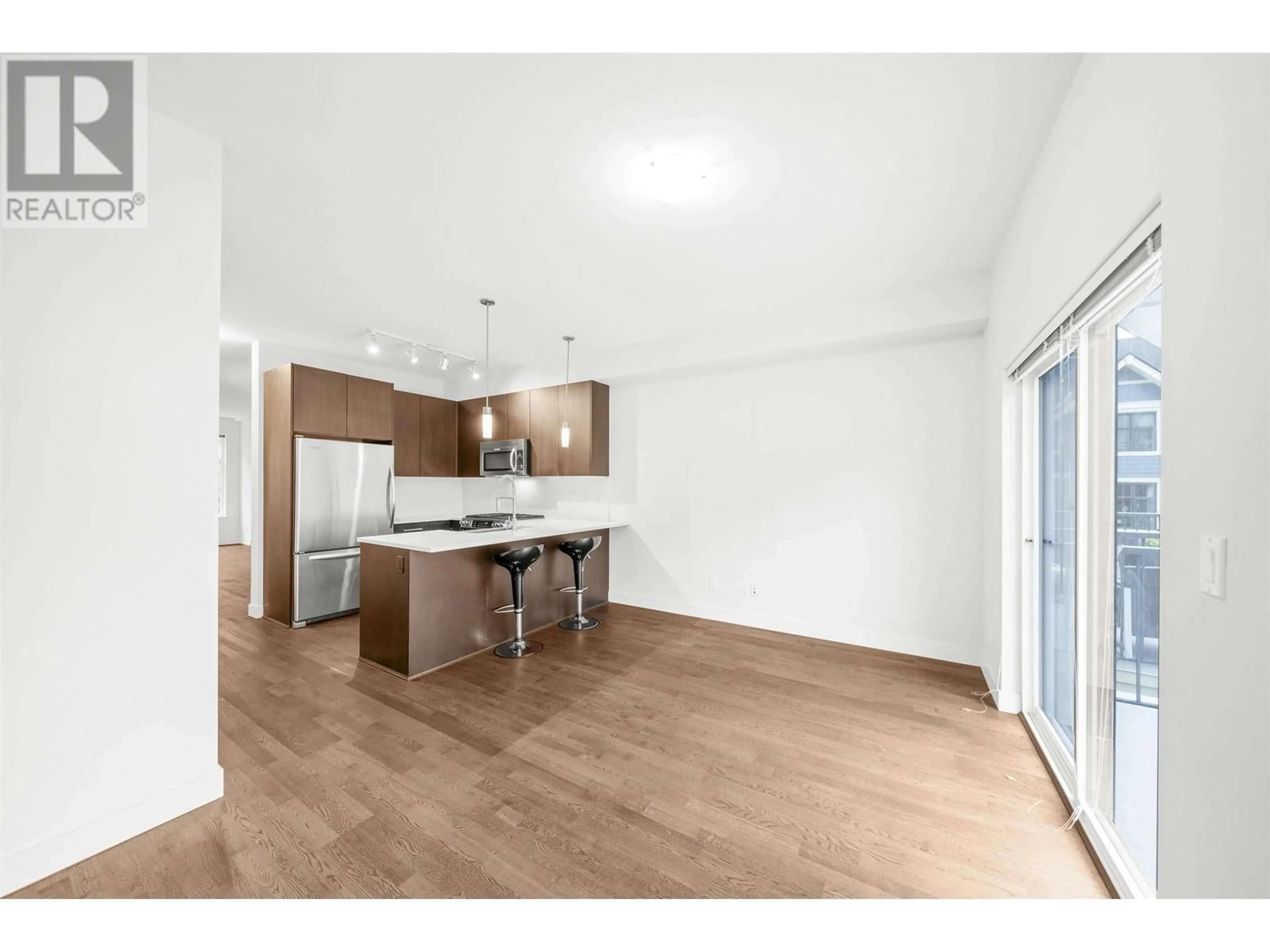 Open concept kitchen, wood/laminate floor for 703 8485 NEW HAVEN CLOSE, Burnaby British Columbia V5J0B7