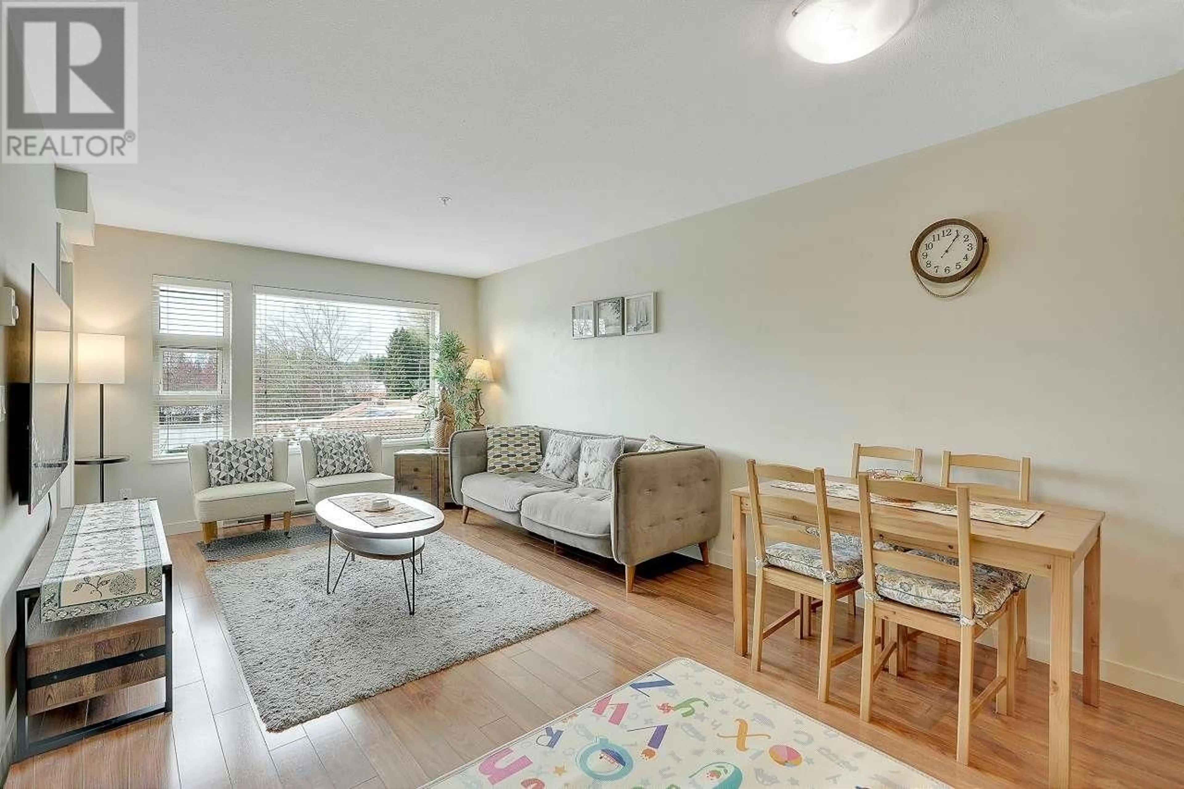 Living room with furniture, wood/laminate floor for 306 1677 LLOYD AVENUE, North Vancouver British Columbia V7P0B1