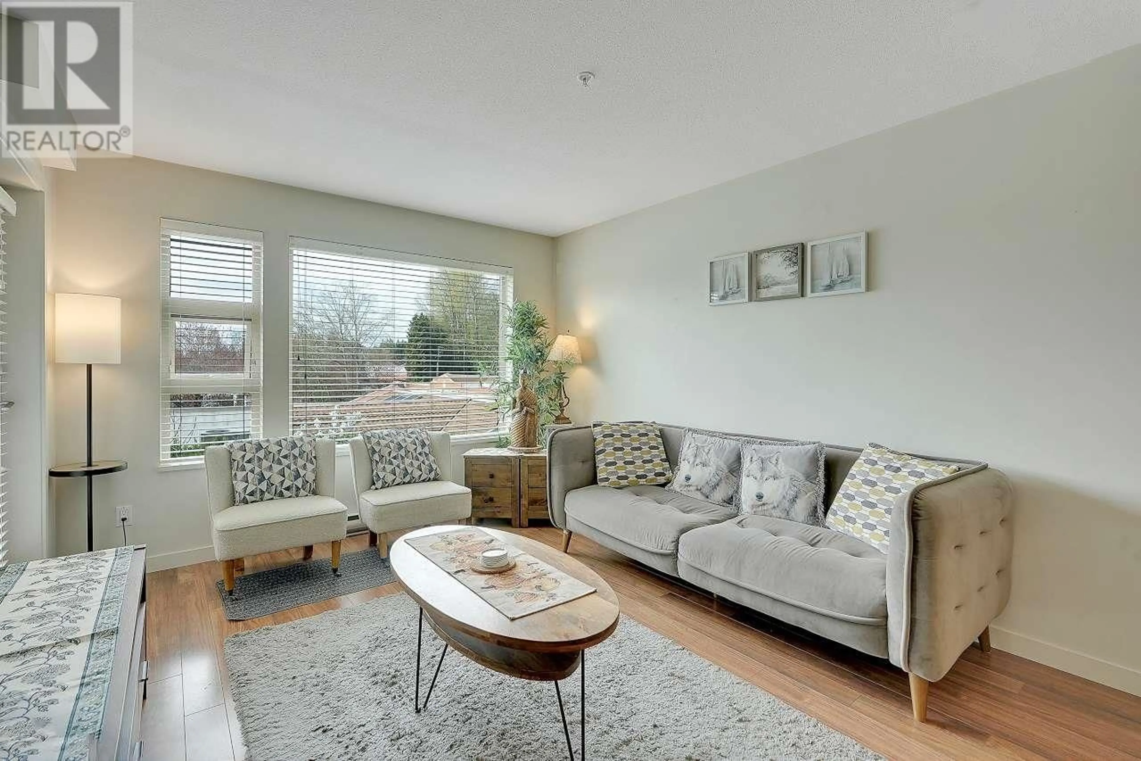 Living room with furniture, wood/laminate floor for 306 1677 LLOYD AVENUE, North Vancouver British Columbia V7P0B1