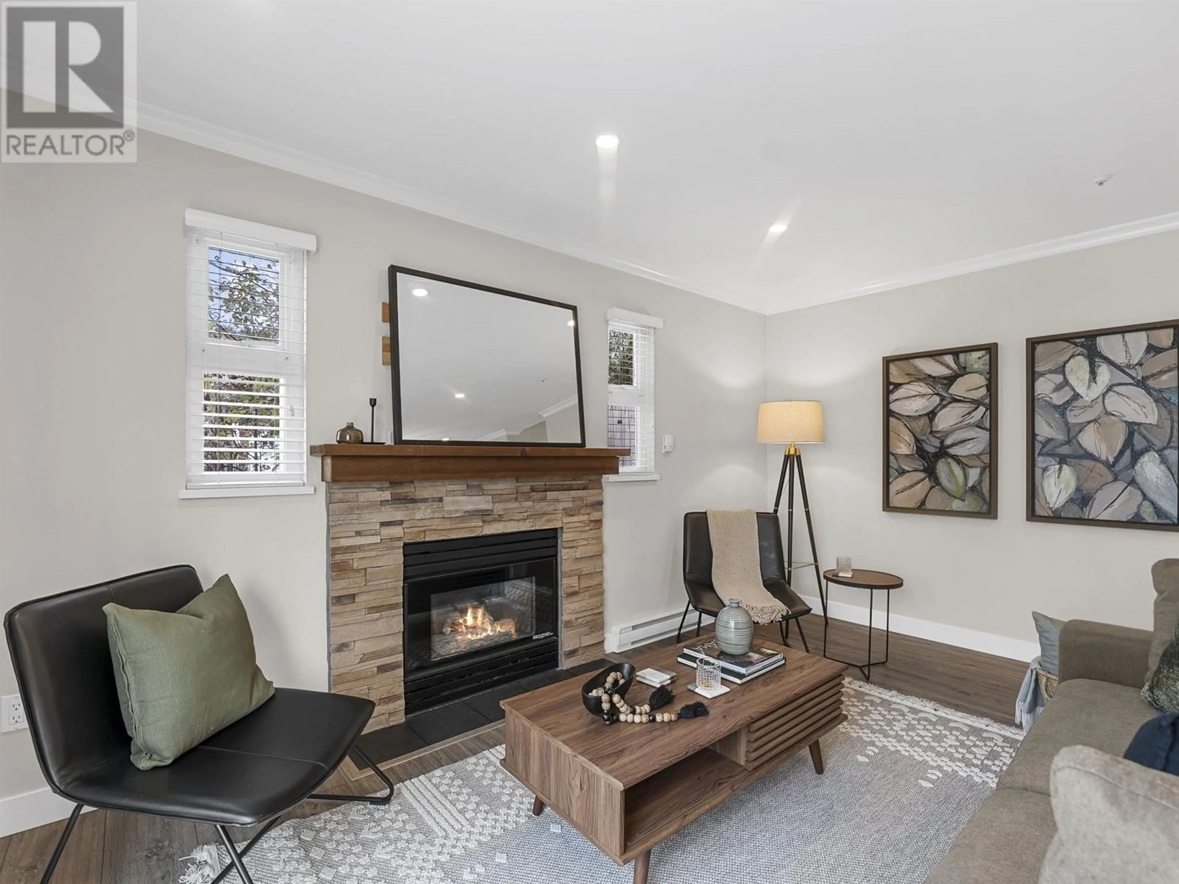 Living room with furniture, wood/laminate floor for 102 3709 PENDER STREET, Burnaby British Columbia V5C2L2