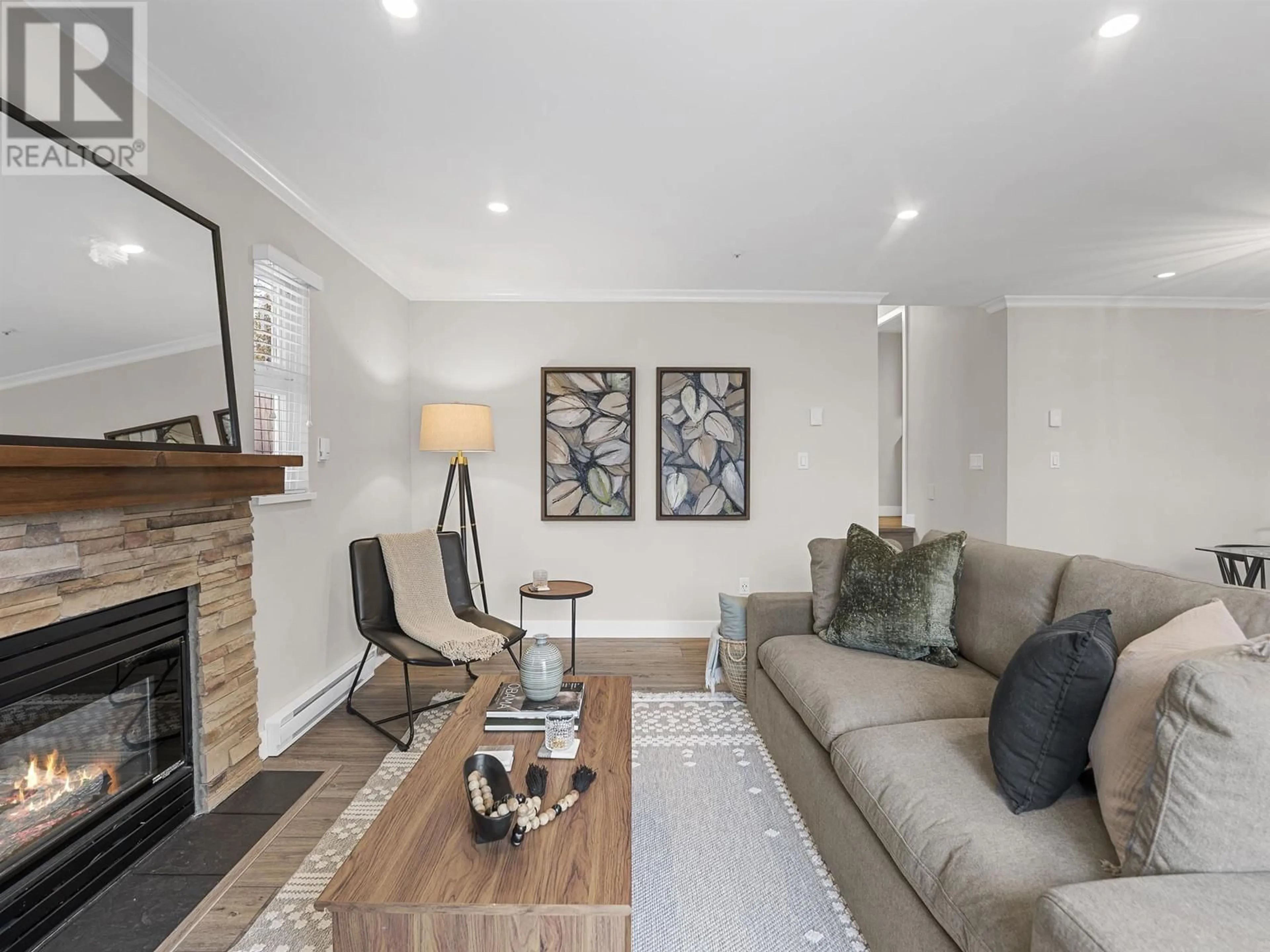 Living room with furniture, wood/laminate floor for 102 3709 PENDER STREET, Burnaby British Columbia V5C2L2