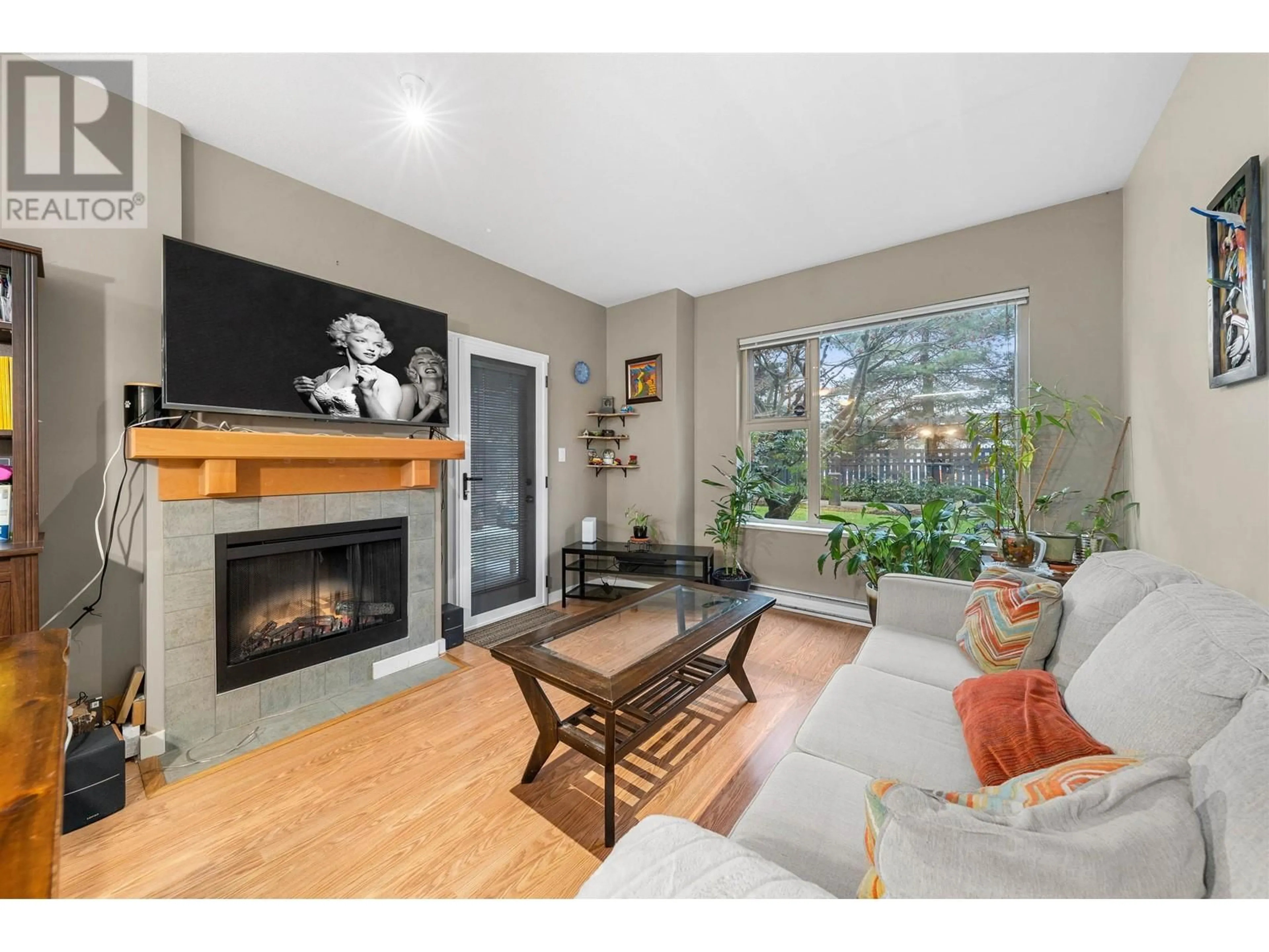 Living room with furniture, wood/laminate floor for 108 808 SANGSTER PLACE, New Westminster British Columbia V3L5W3