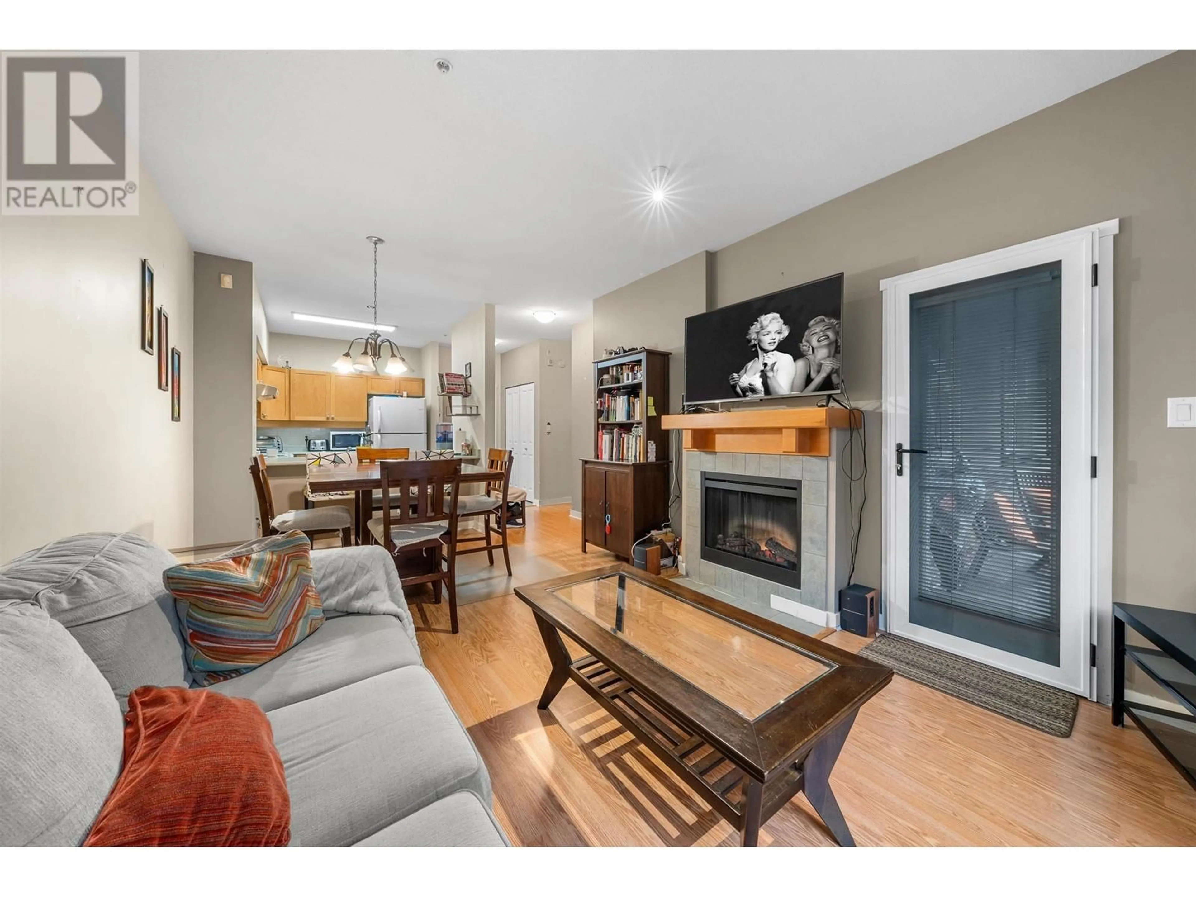 Living room with furniture, wood/laminate floor for 108 808 SANGSTER PLACE, New Westminster British Columbia V3L5W3