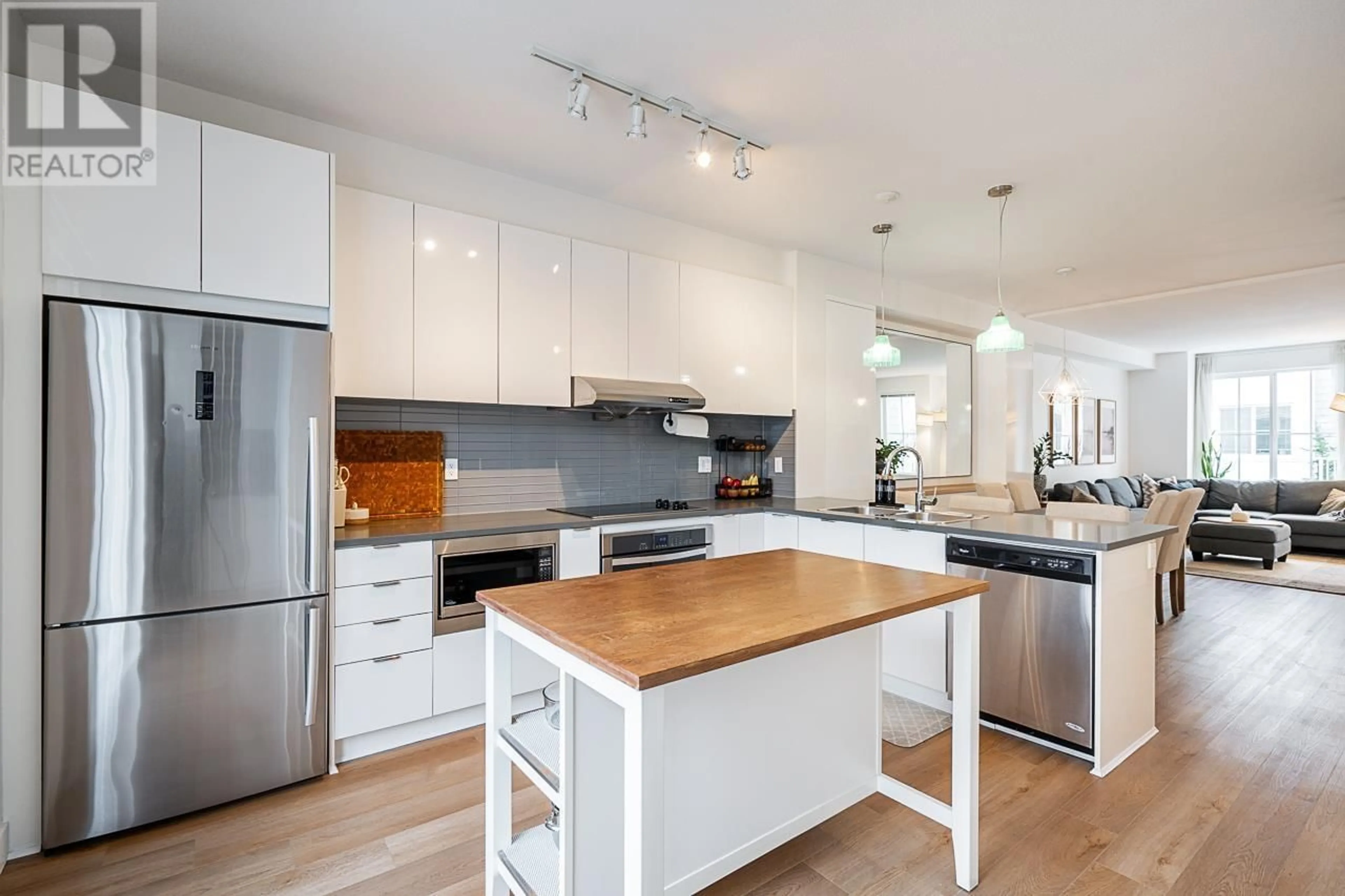 Open concept kitchen, wood/laminate floor for 27 5550 ADMIRAL WAY, Delta British Columbia V4K0C4