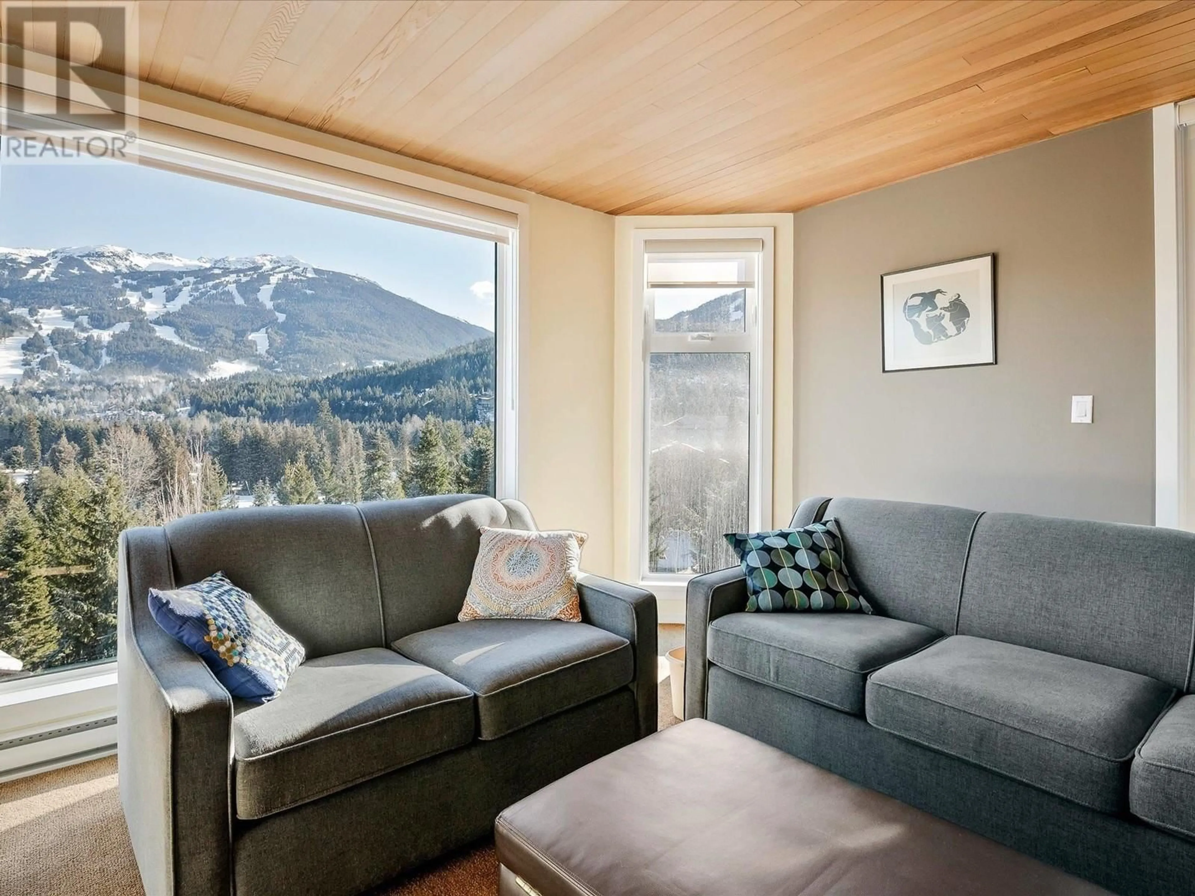 Living room with furniture, wood/laminate floor for 205 - 3217 BLUEBERRY DRIVE, Whistler British Columbia V8E0B8