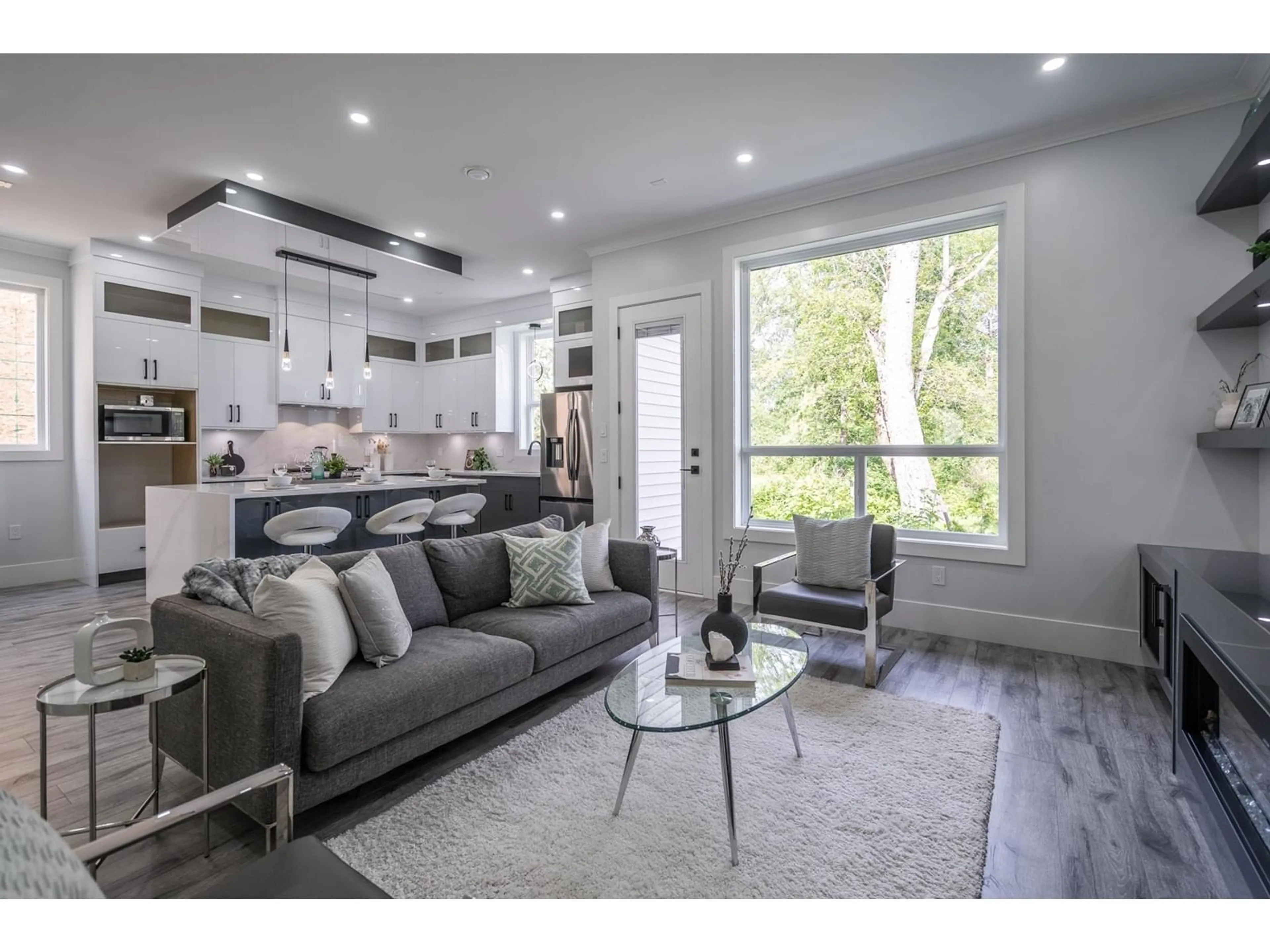 Living room with furniture, wood/laminate floor for 7518 205A, Langley British Columbia V2Y1V5