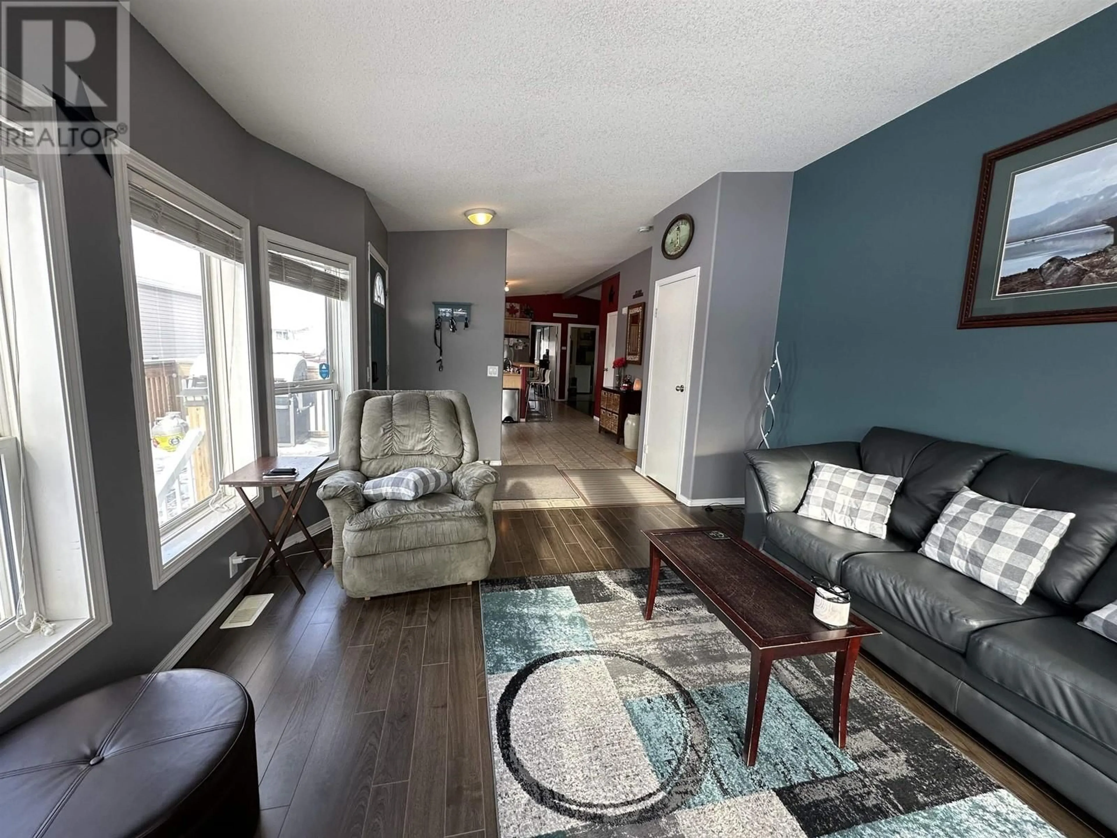 Living room with furniture, wood/laminate floor for 8912 98 AVENUE, Fort St. John British Columbia V1J7G8