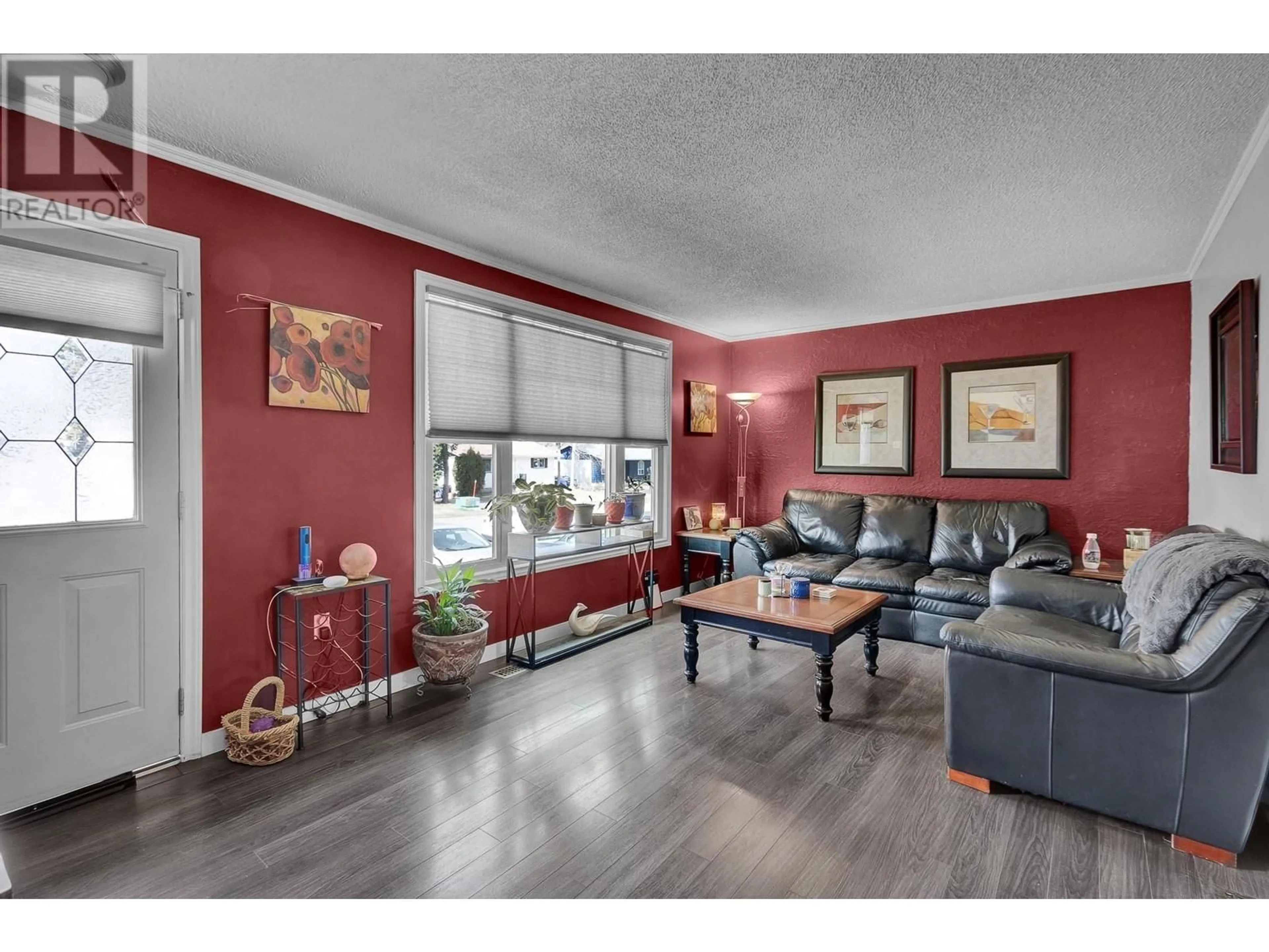 Living room with furniture, wood/laminate floor for 7670 LOYOLA DRIVE, Prince George British Columbia V2N2X1