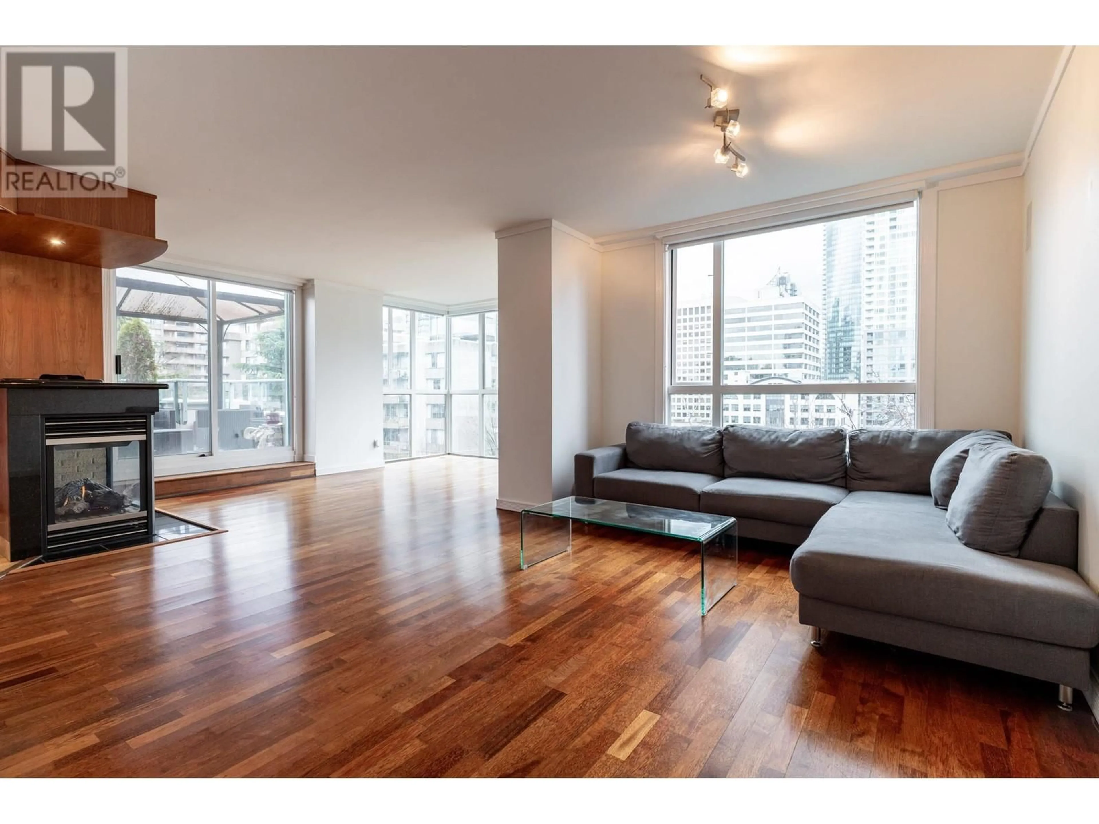 Living room with furniture, wood/laminate floor for 704 - 1132 HARO STREET, Vancouver British Columbia V6E1C9