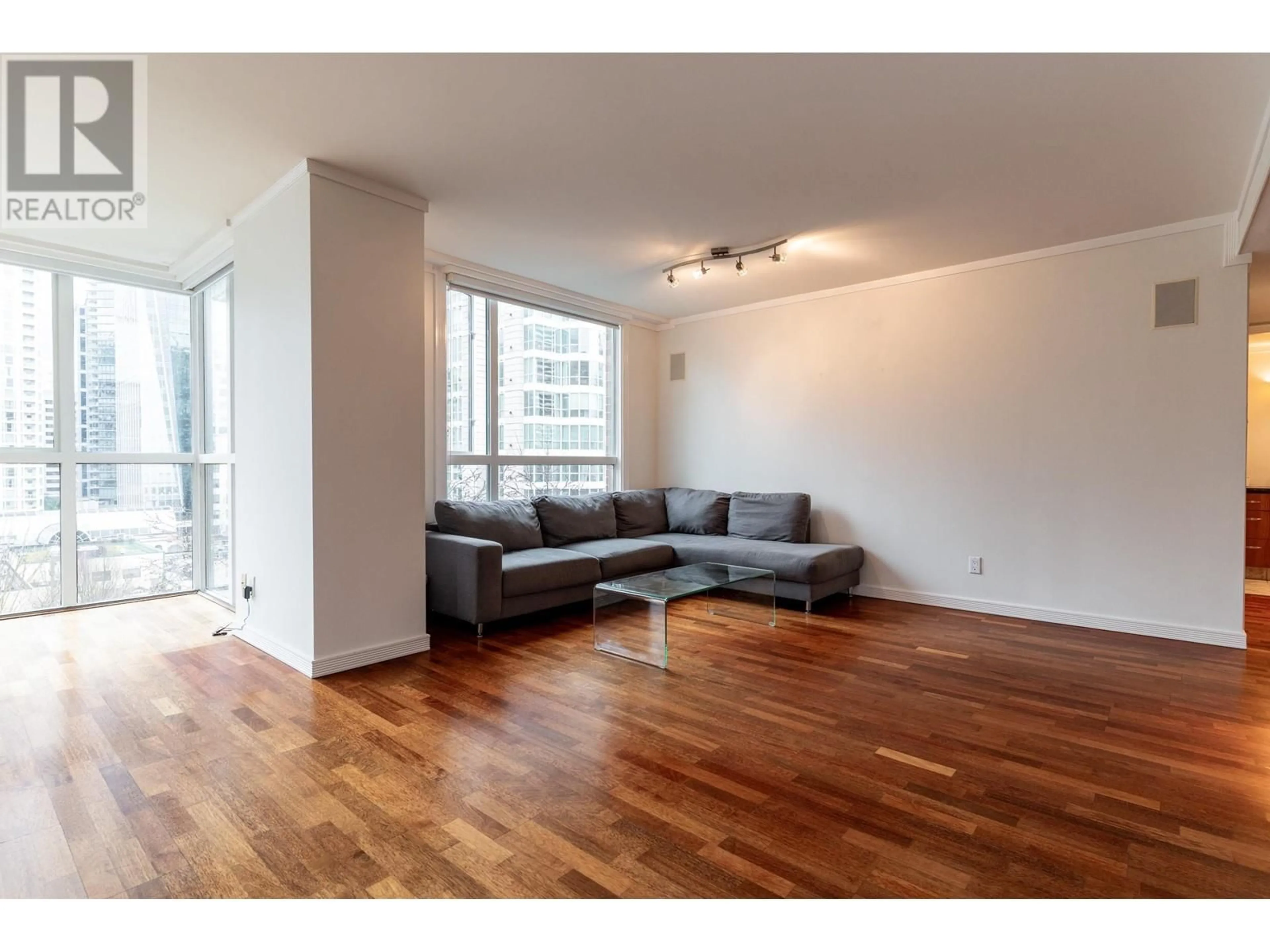 Living room with furniture, wood/laminate floor for 704 - 1132 HARO STREET, Vancouver British Columbia V6E1C9