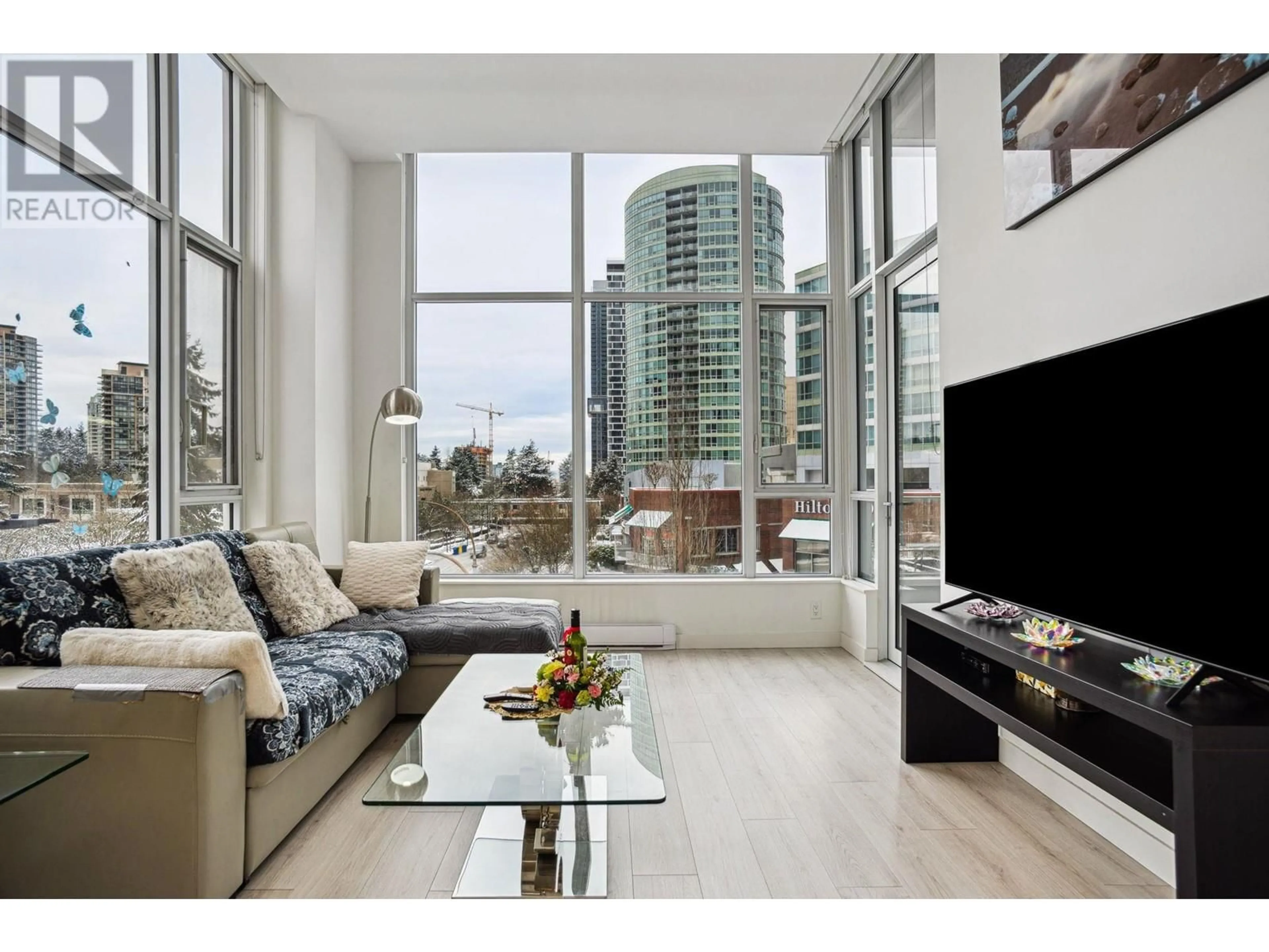 Living room with furniture, wood/laminate floor for 308 - 6080 MCKAY AVENUE, Burnaby British Columbia V5H0J4