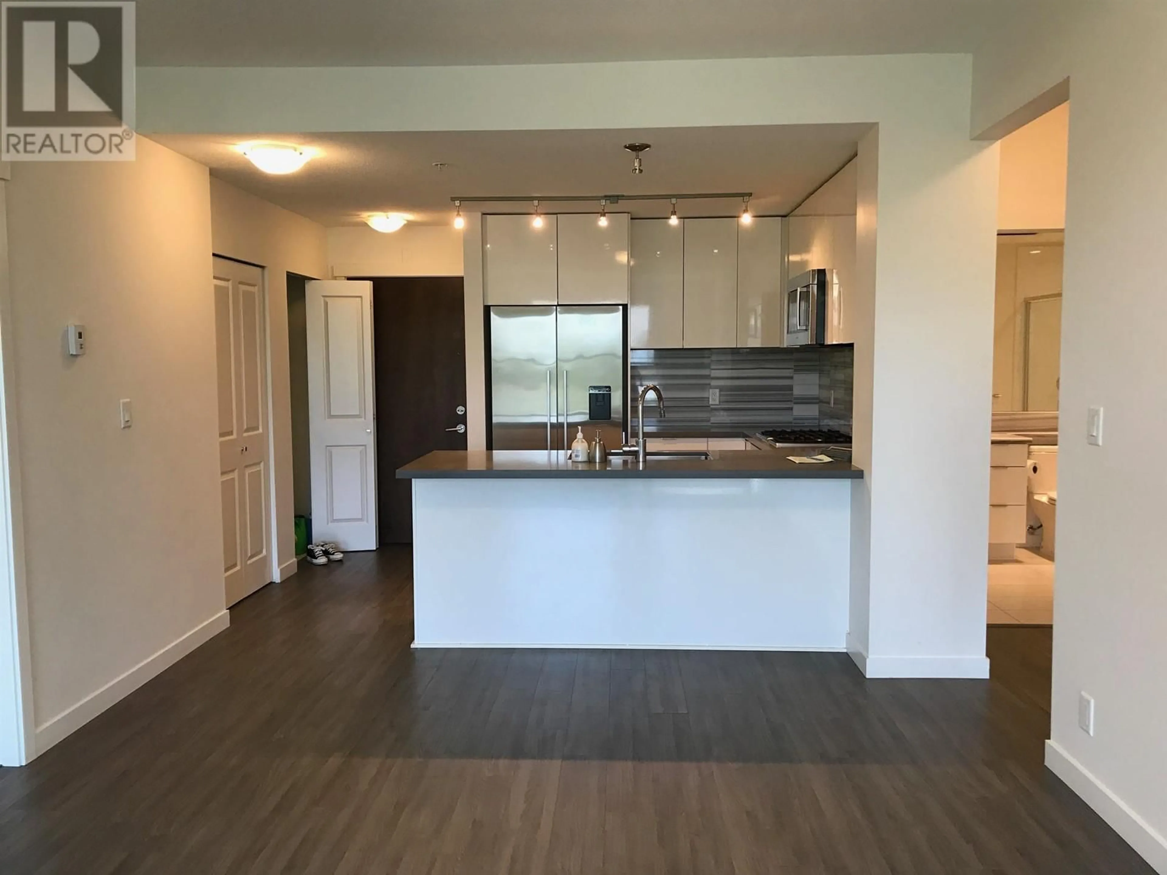 Open concept kitchen, wood/laminate floor for 203 3138 RIVERWALK AVENUE, Vancouver British Columbia V5S0B6