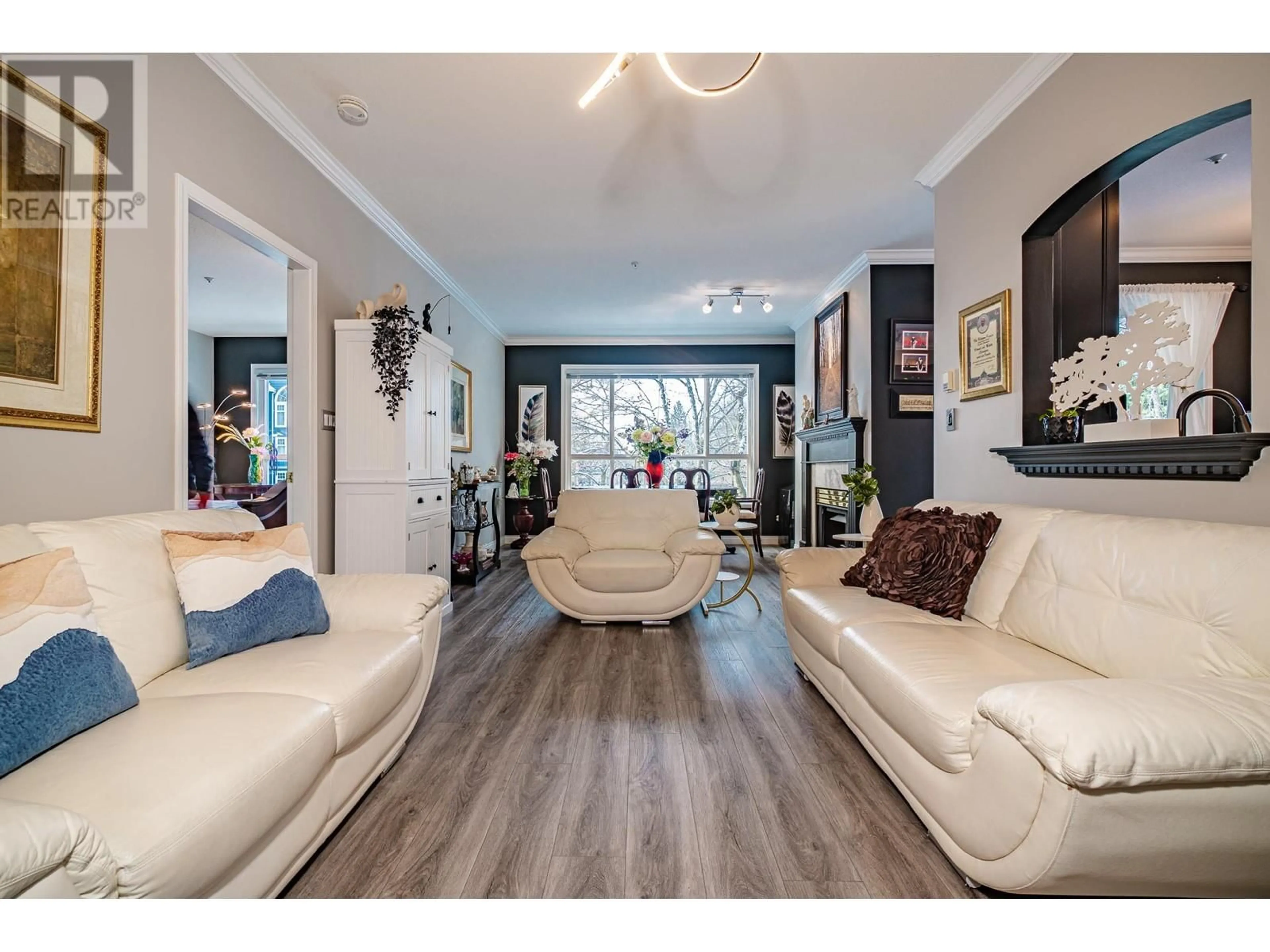 Living room with furniture, wood/laminate floor for 209 3098 GUILDFORD WAY, Coquitlam British Columbia V3B7W8