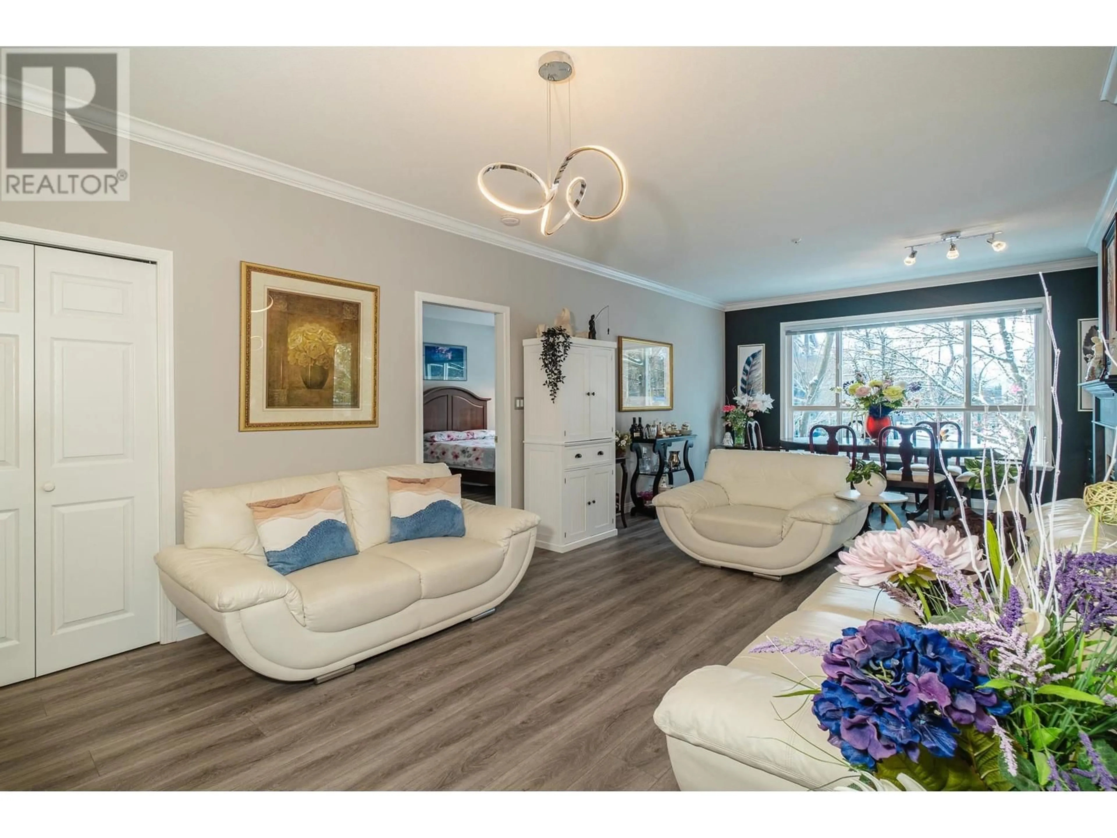 Living room with furniture, wood/laminate floor for 209 3098 GUILDFORD WAY, Coquitlam British Columbia V3B7W8