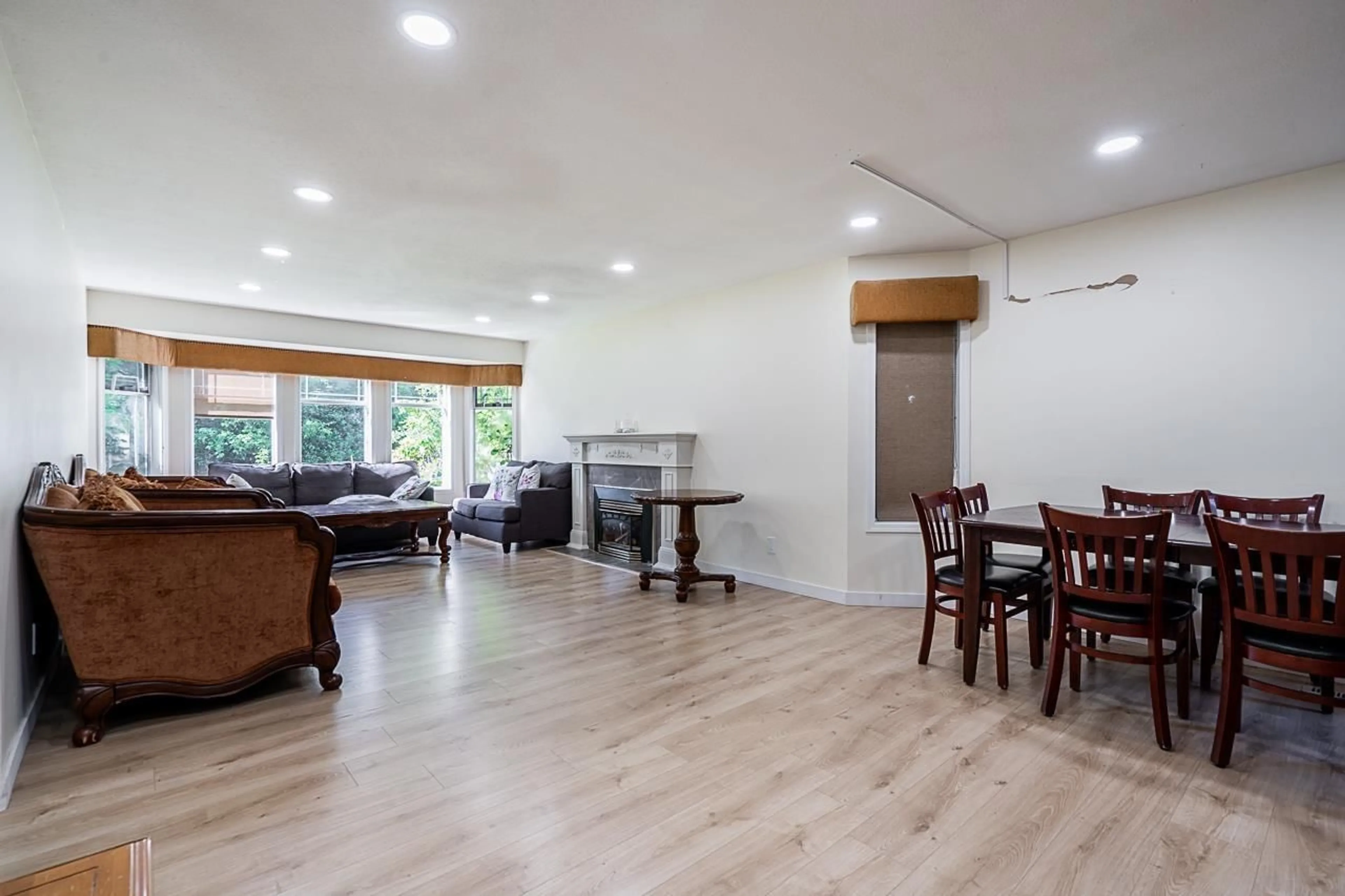 Living room with furniture, wood/laminate floor for 11142 85A AVENUE, Delta British Columbia V4C7C8