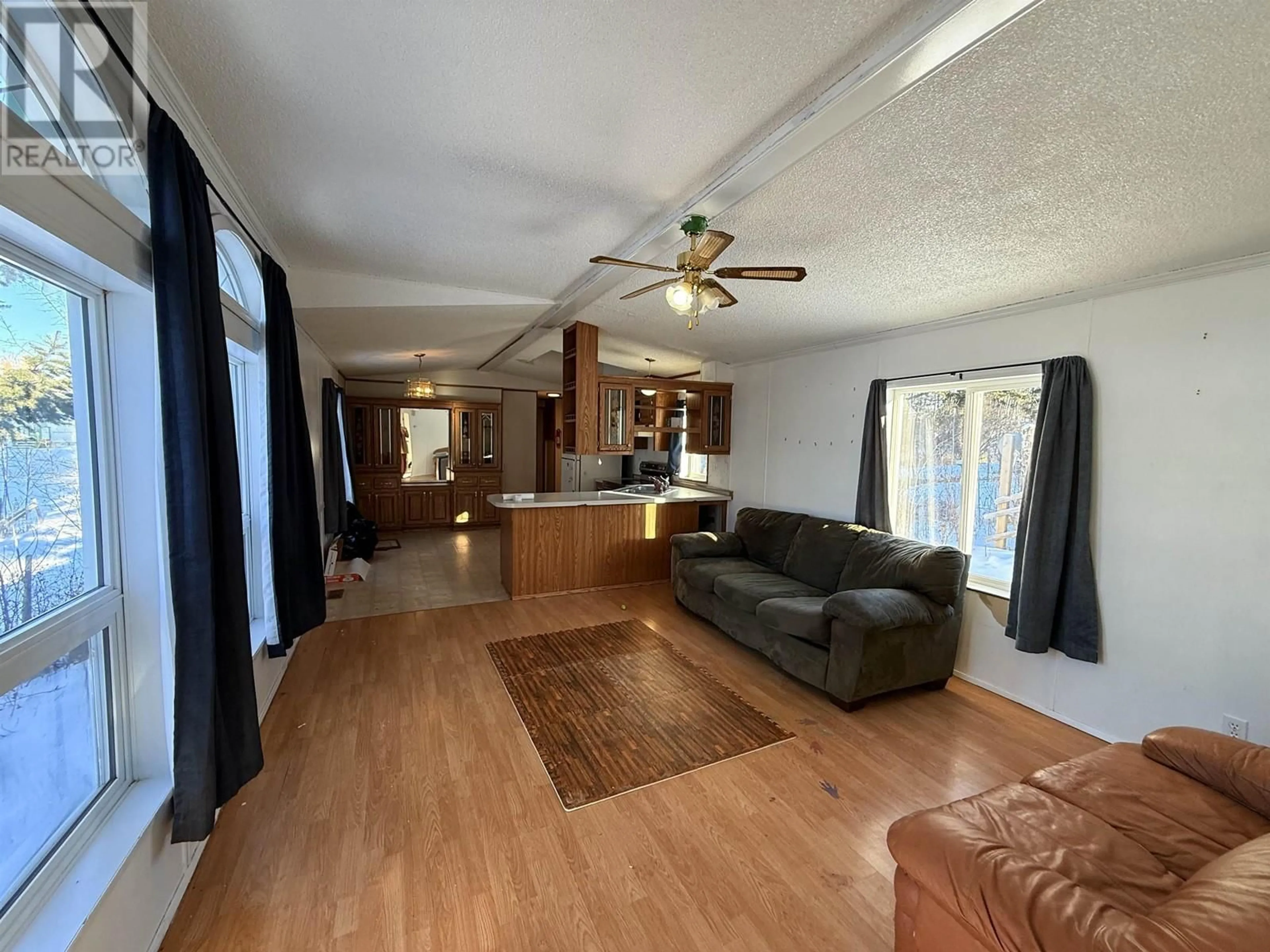 Living room with furniture, wood/laminate floor for 5395 PARK DRIVE, 103 Mile House British Columbia V0K2E1