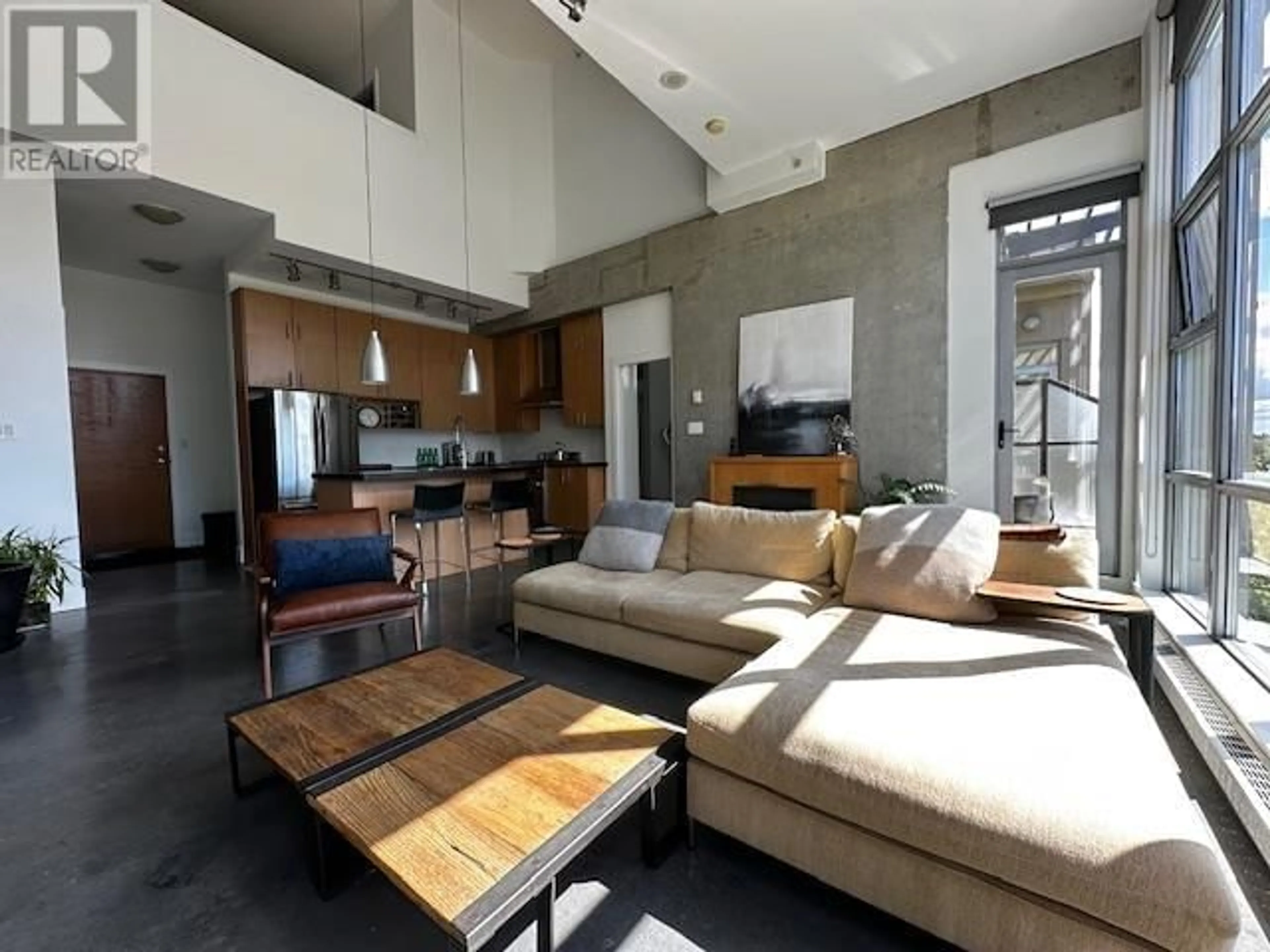 Living room with furniture, cement floor for 603 2635 PRINCE EDWARD STREET, Vancouver British Columbia V5T4V7