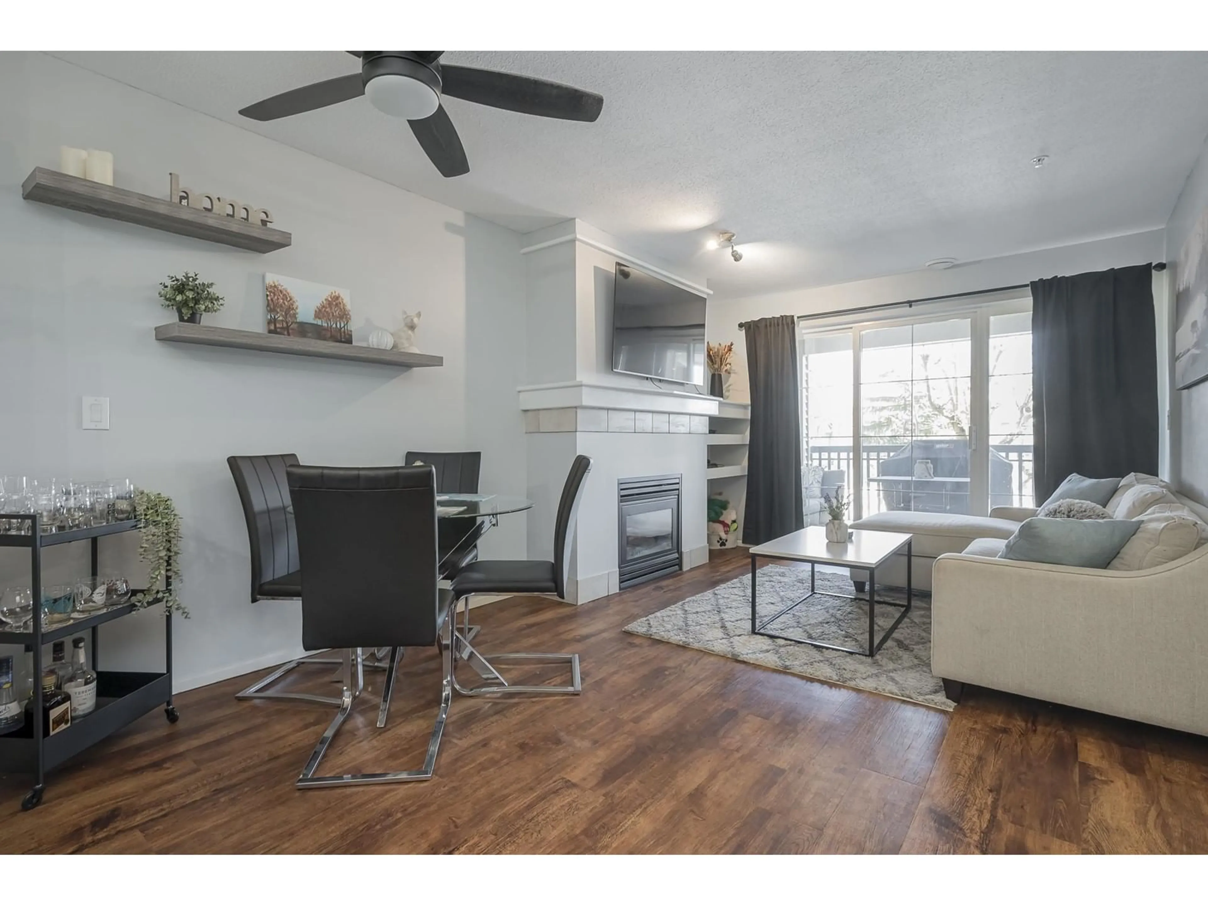 Living room with furniture, wood/laminate floor for 211 6336 197 STREET, Langley British Columbia V2Y2T7