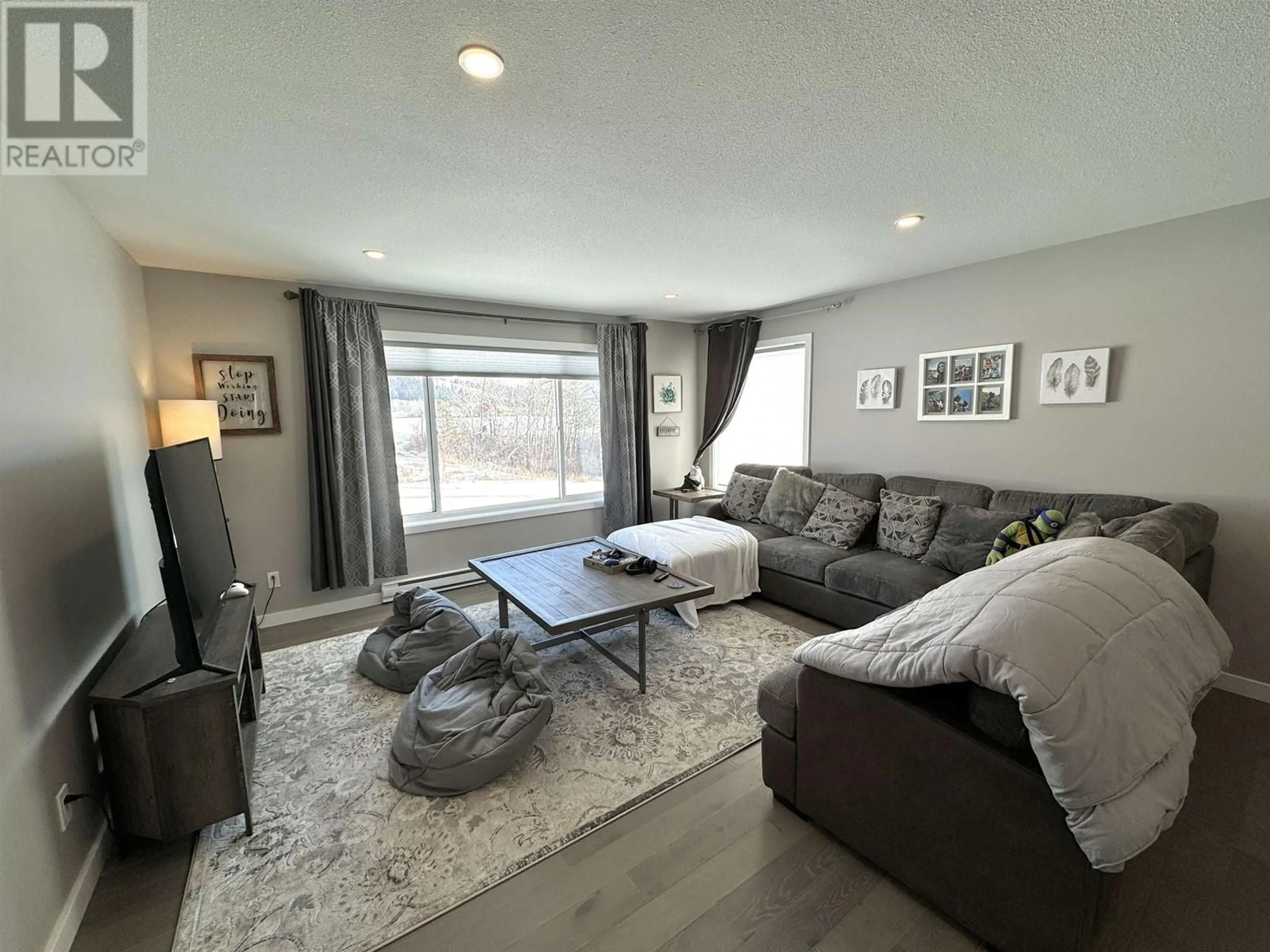 Living room with furniture, wood/laminate floor for 199 COYOTE ROCK DRIVE, Williams Lake British Columbia V2G0B1