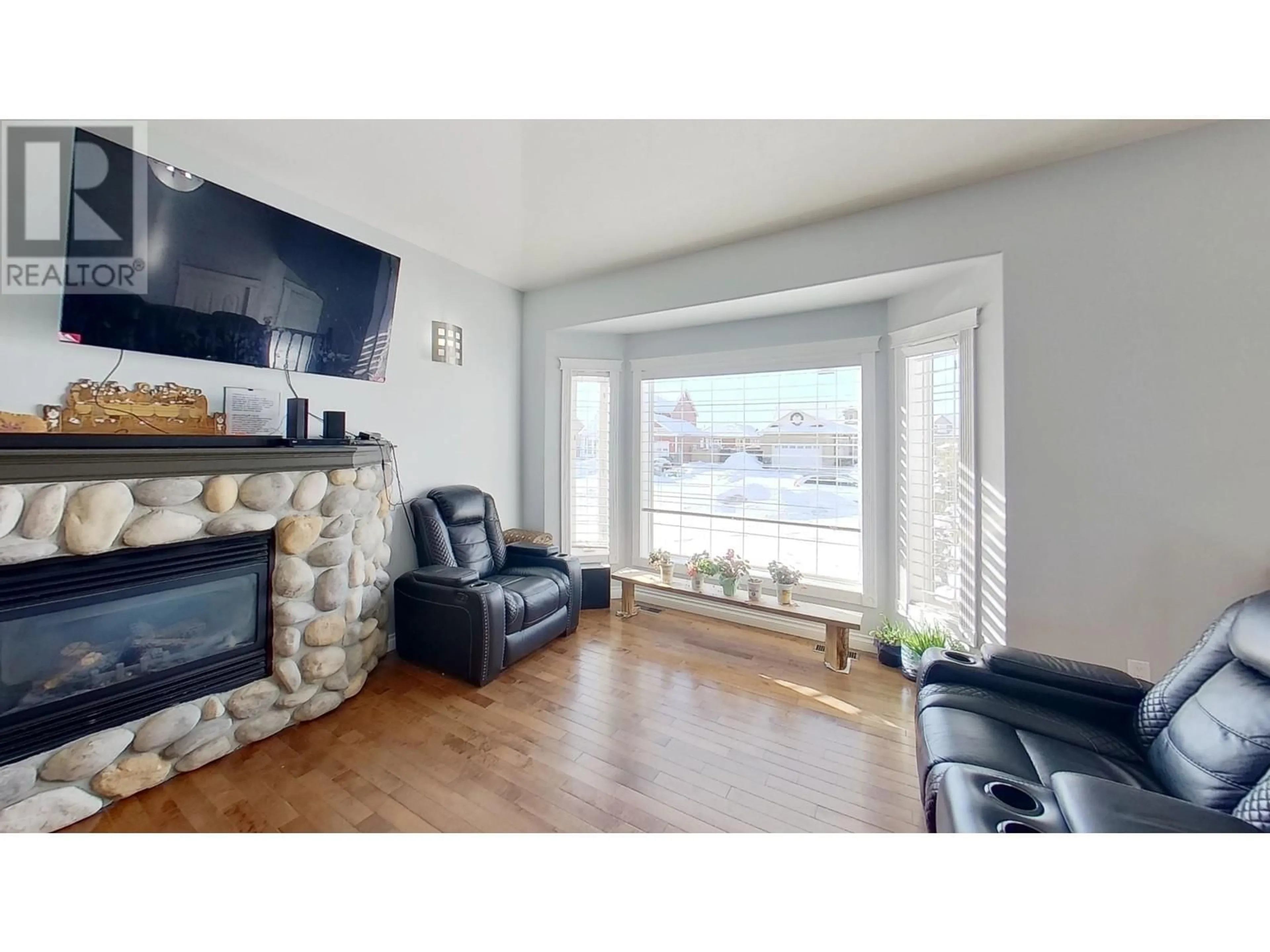 Living room with furniture, wood/laminate floor for 11023 86A STREET, Fort St. John British Columbia V1J0A6