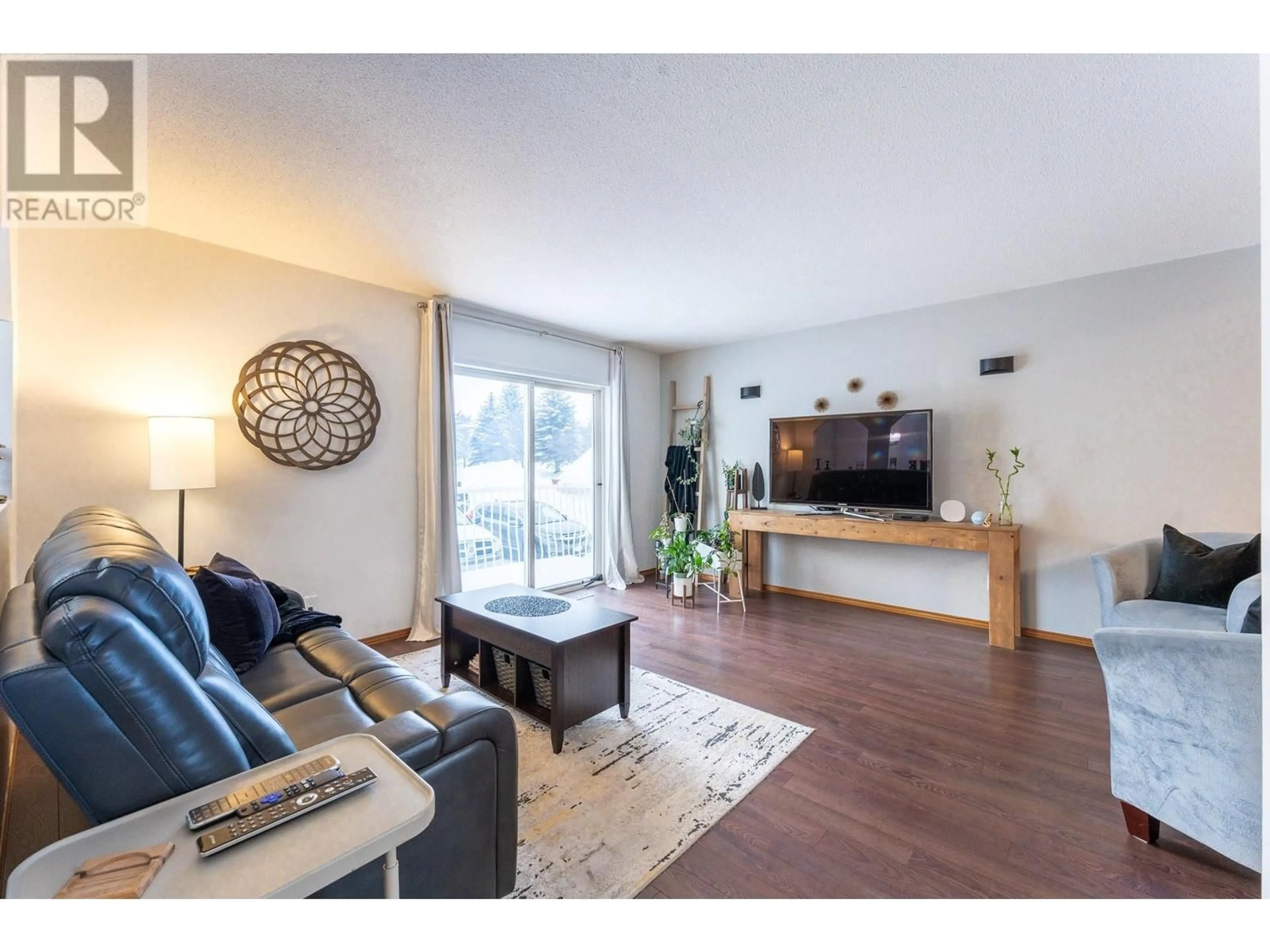 Living room with furniture, wood/laminate floor for 106 3015 ST ANNE CRESCENT, Prince George British Columbia V2N5C7