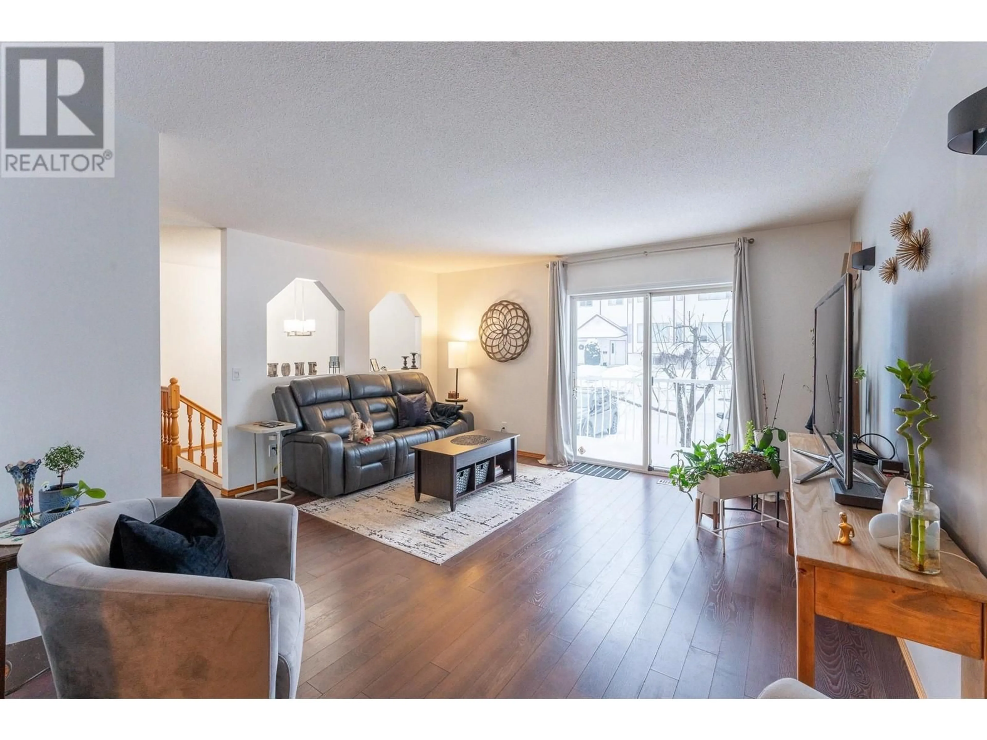 Living room with furniture, wood/laminate floor for 106 3015 ST ANNE CRESCENT, Prince George British Columbia V2N5C7