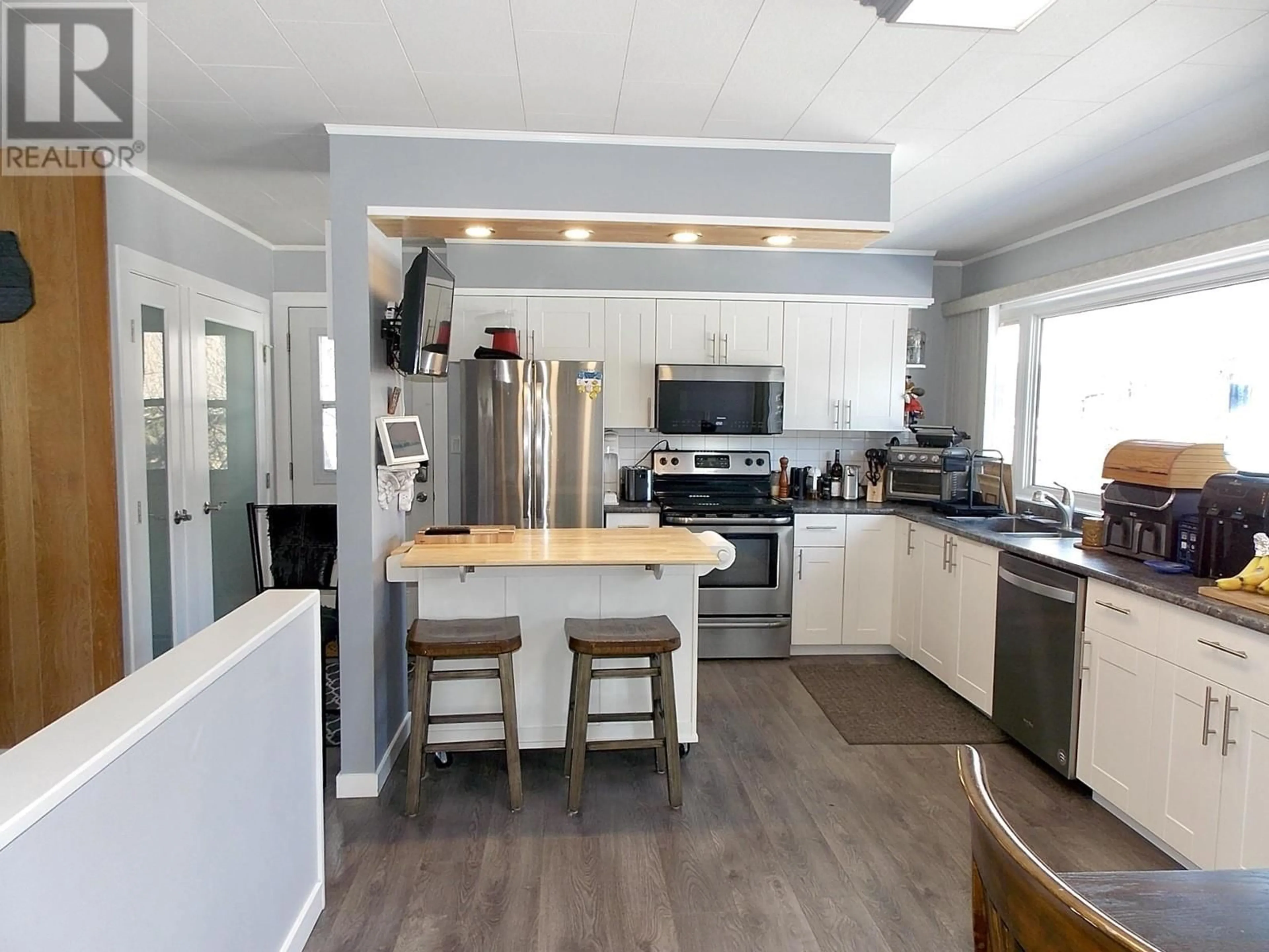 Open concept kitchen, wood/laminate floor for 711 WESTERN AVENUE, Williams Lake British Columbia V2G2J2