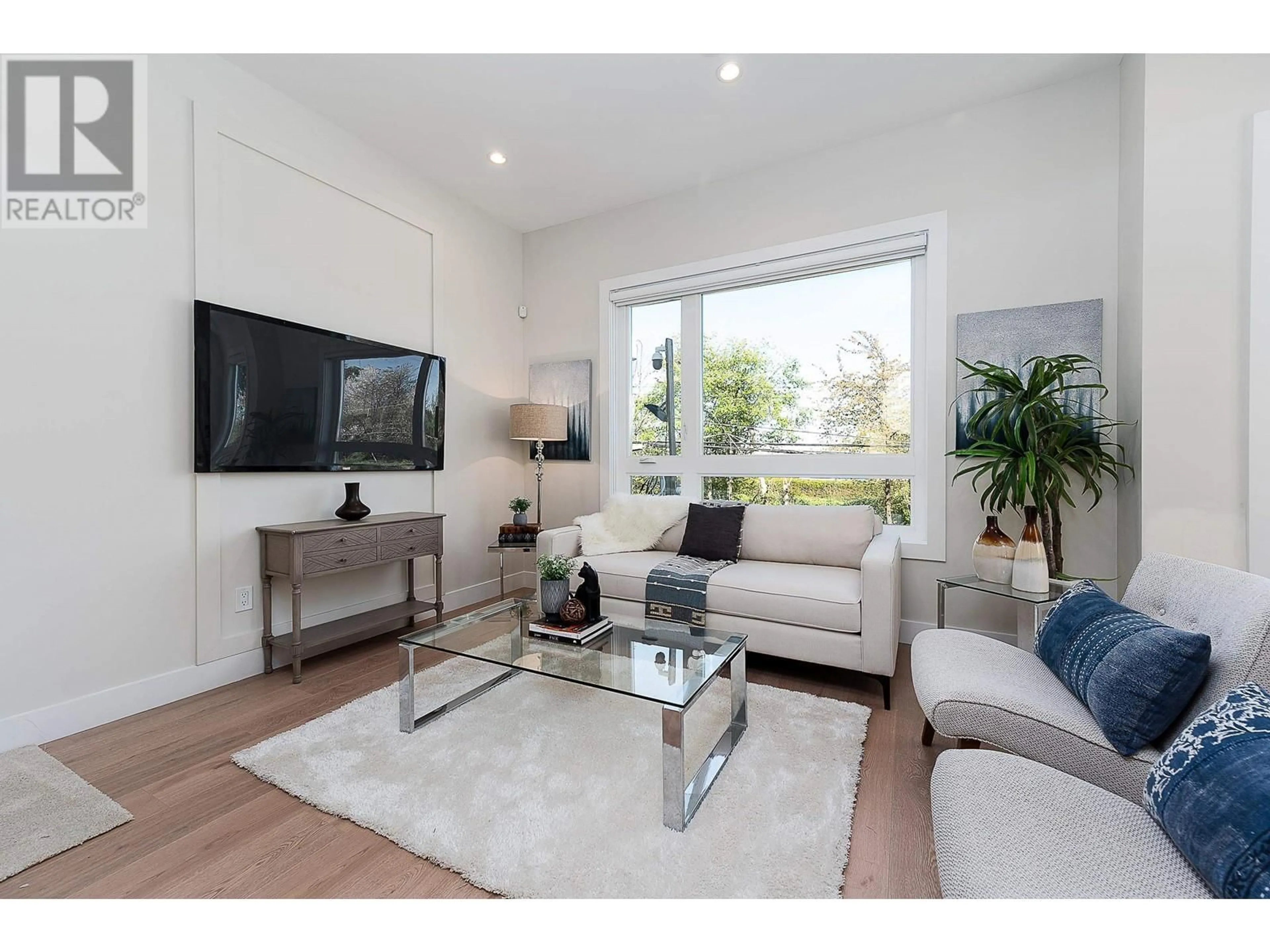 Living room with furniture, wood/laminate floor for 10 3033 SHELL ROAD, Richmond British Columbia V6X0B8