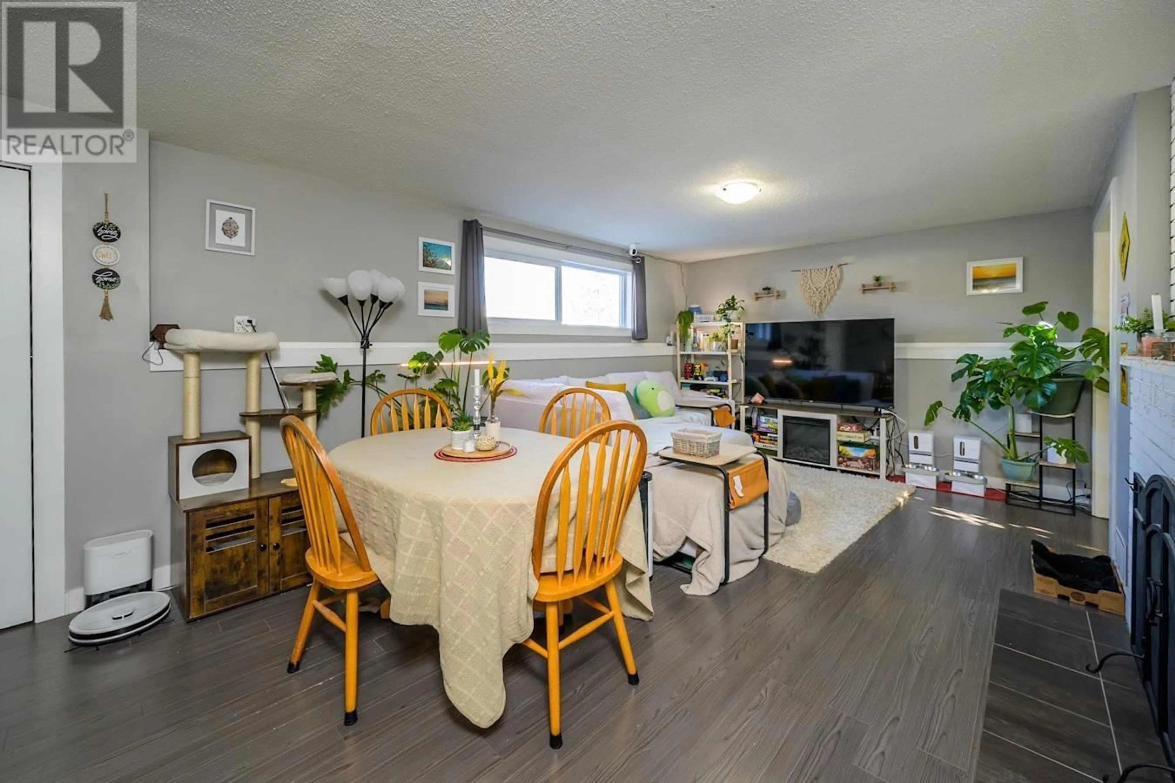 Living room with furniture, wood/laminate floor for 2003 MCBRIDE CRESCENT, Prince George British Columbia V2M1Z2