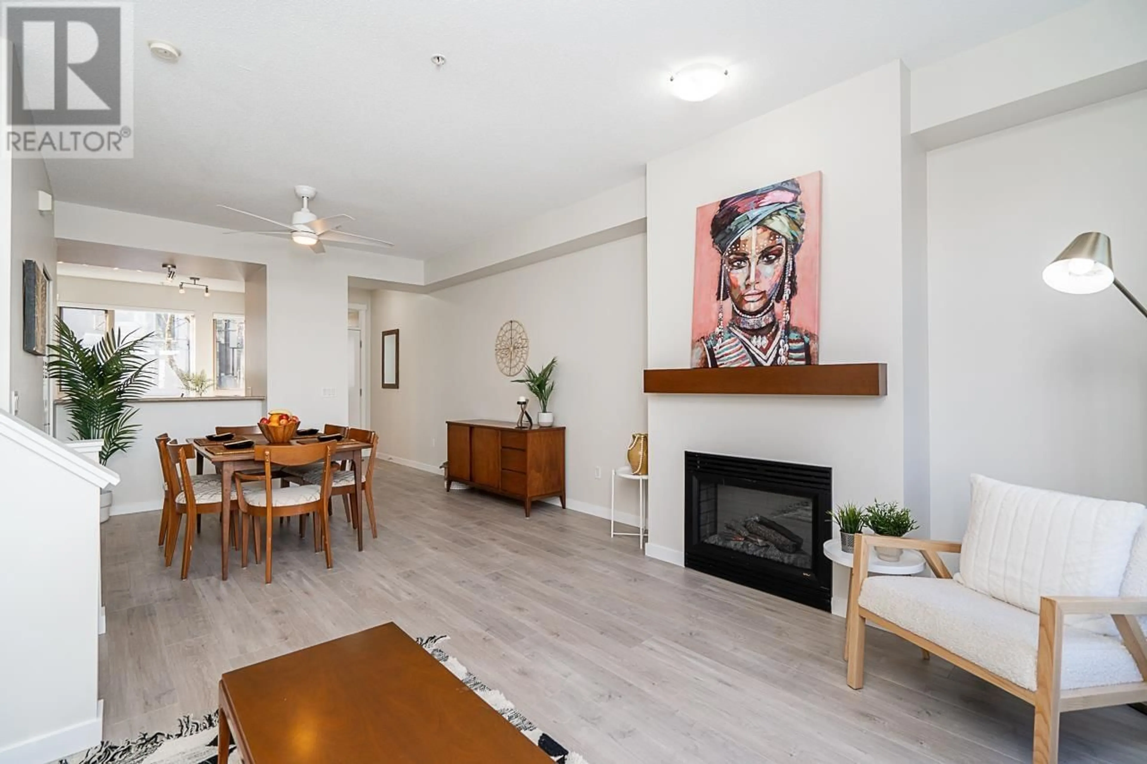 Living room with furniture, wood/laminate floor for 84 - 9229 UNIVERSITY CRESCENT, Burnaby British Columbia V5A4Z2