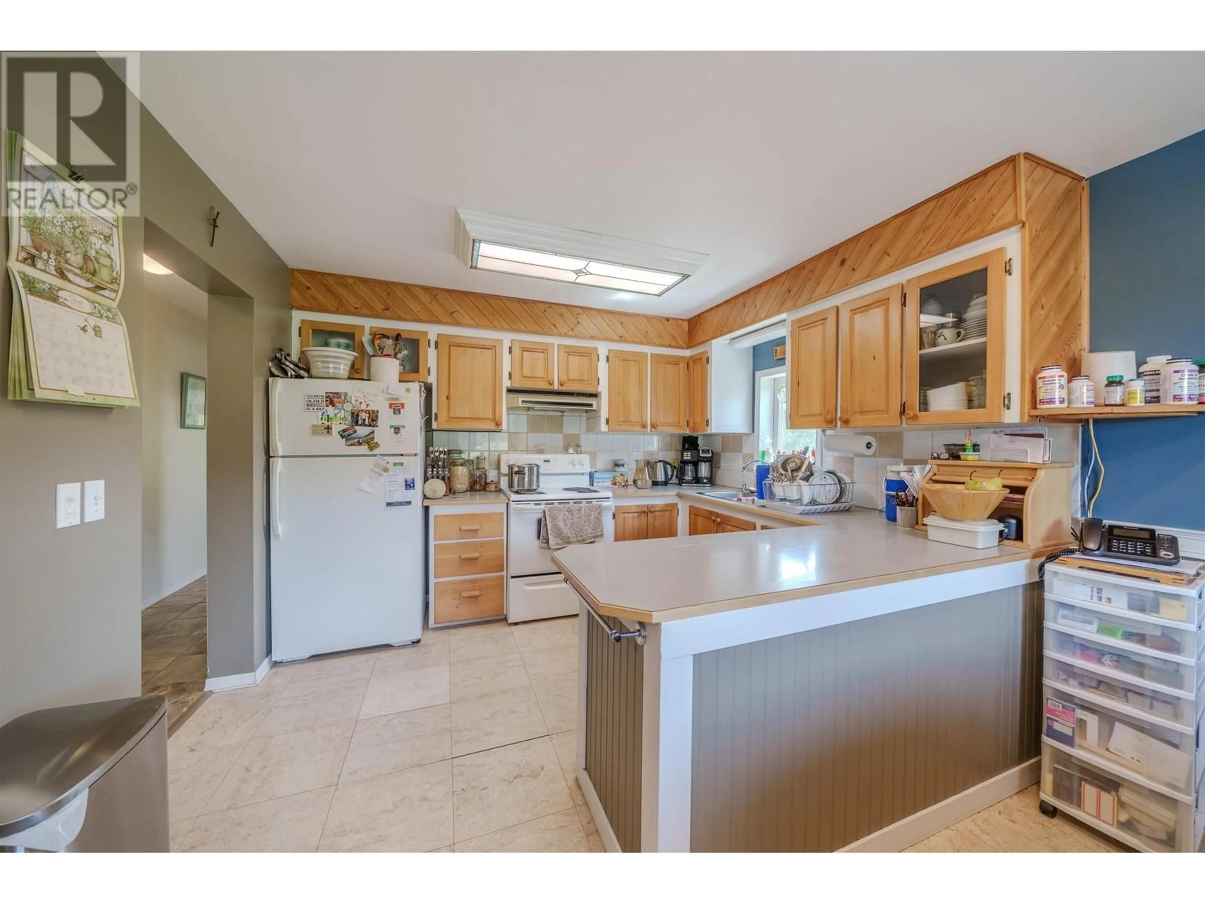 Standard kitchen, ceramic/tile floor for 5501 KENNEDY ROAD, 100 Mile House British Columbia V0K2E0