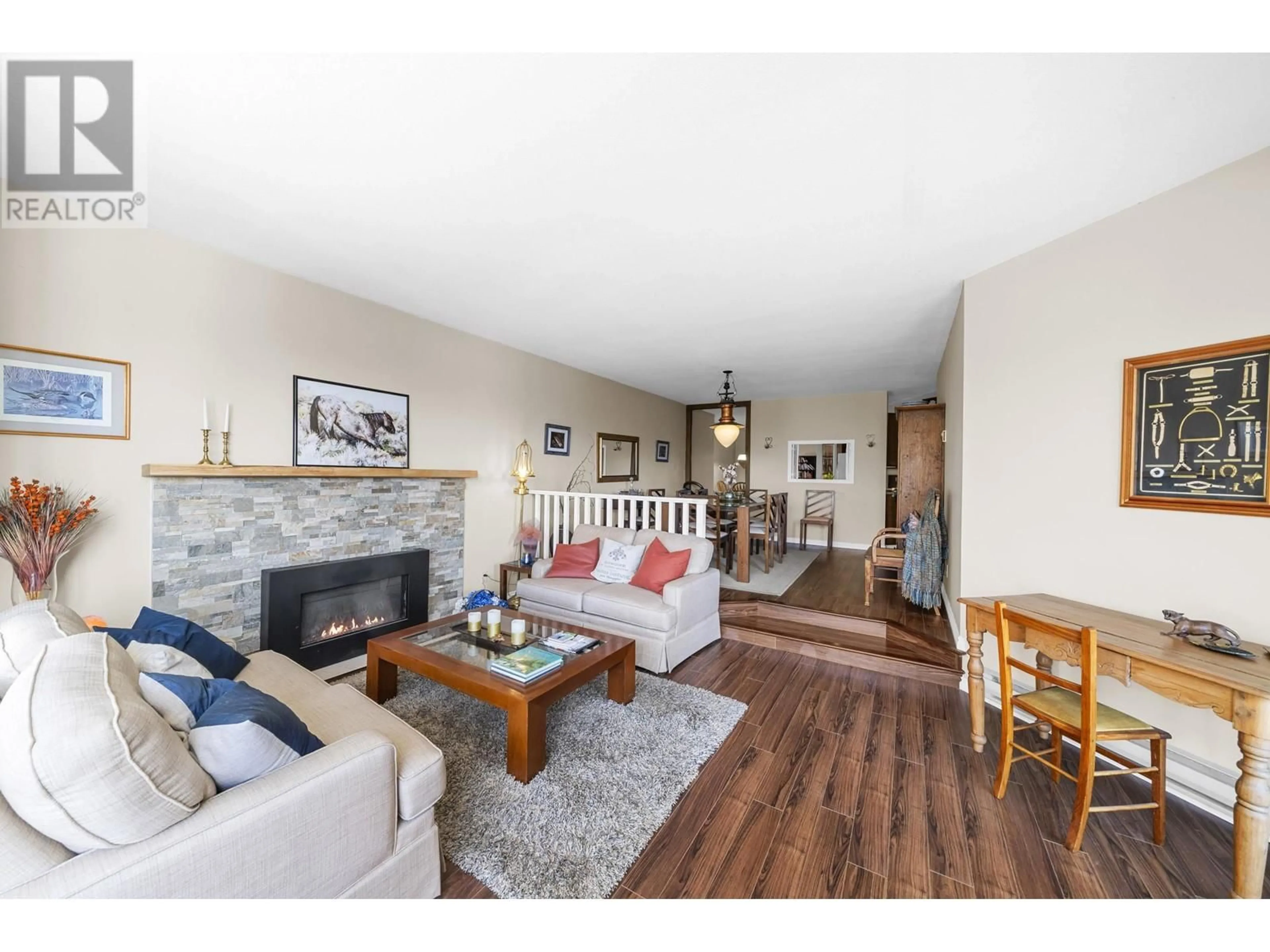 Living room with furniture, wood/laminate floor for 210 999 BERKLEY ROAD, North Vancouver British Columbia V7H1Y3