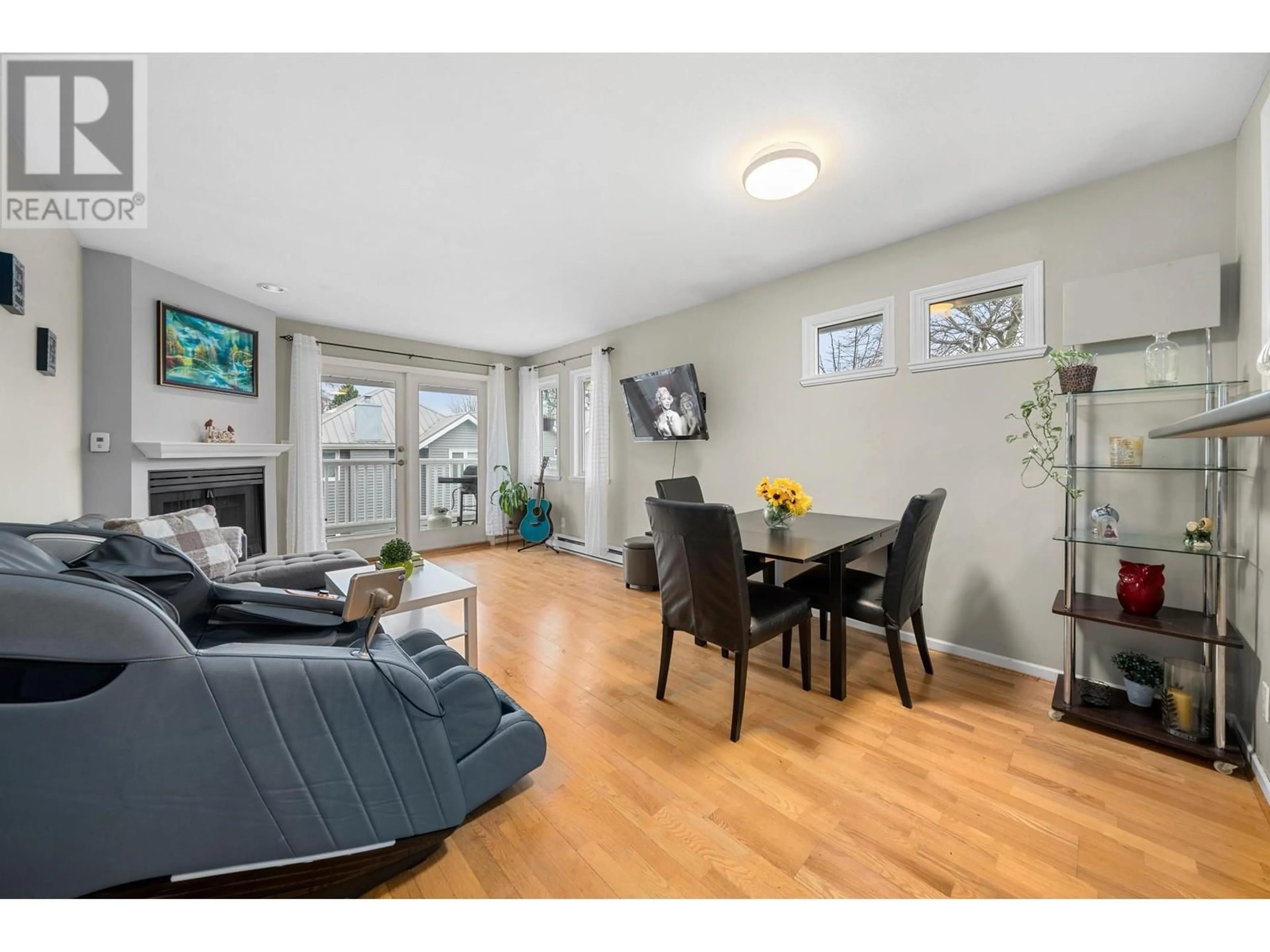 Living room with furniture, wood/laminate floor for 203 1538 BOWSER AVENUE, North Vancouver British Columbia V7P2Y3