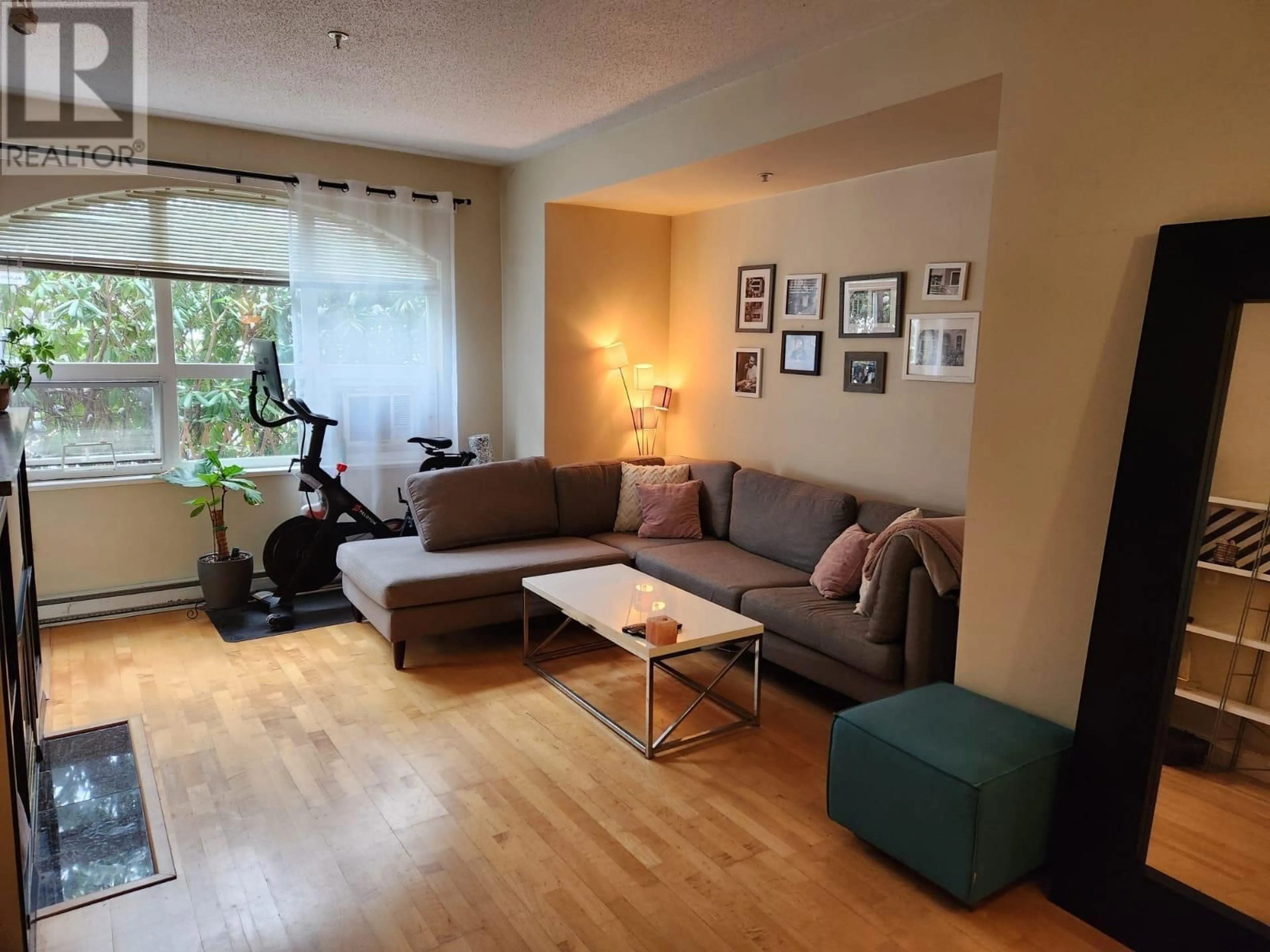 Living room with furniture, wood/laminate floor for 102 5888 DOVER CRESCENT, Richmond British Columbia V7C5R9