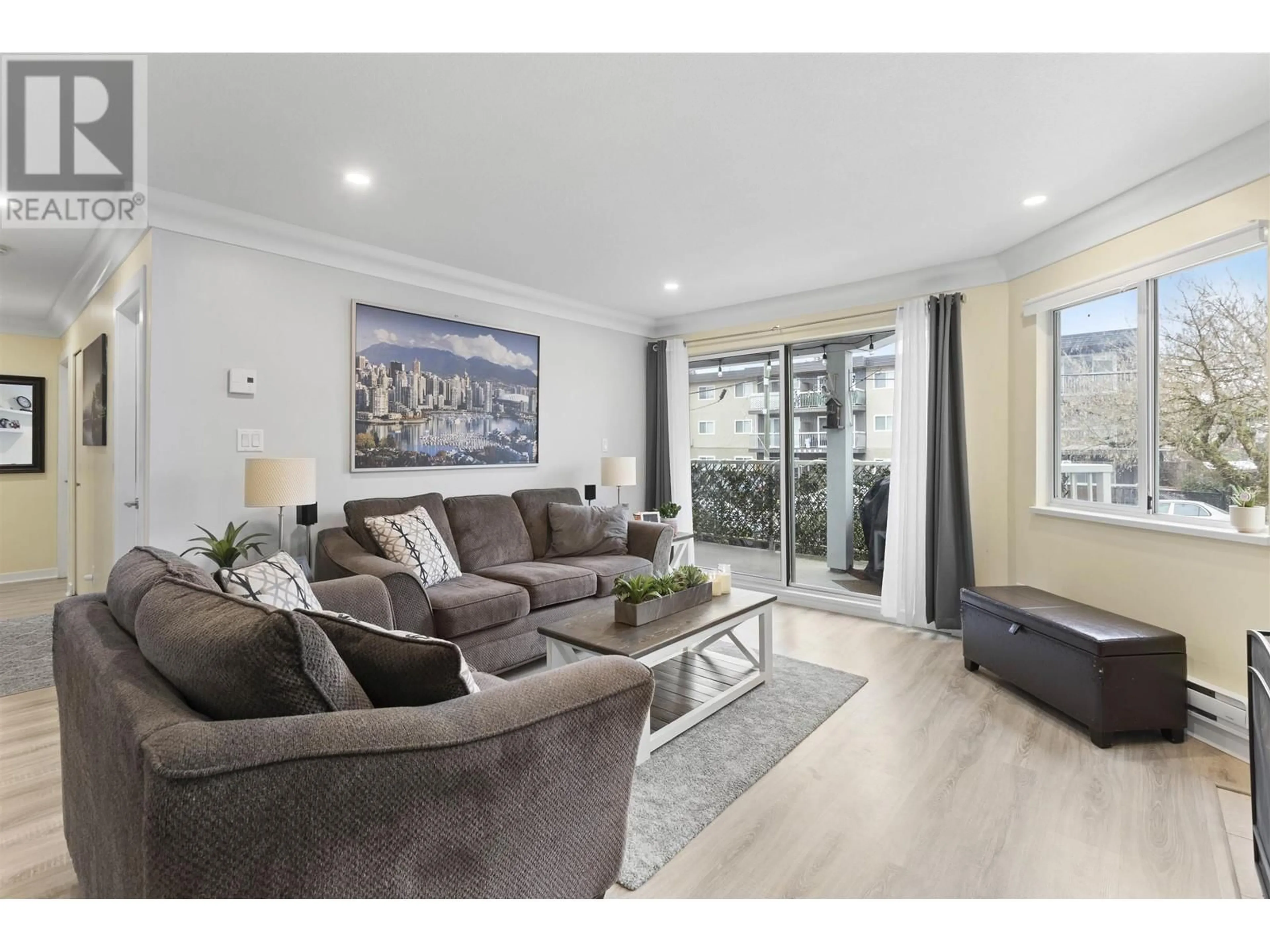 Living room with furniture, wood/laminate floor for 102 22222 119 AVENUE, Maple Ridge British Columbia V2X2Y9