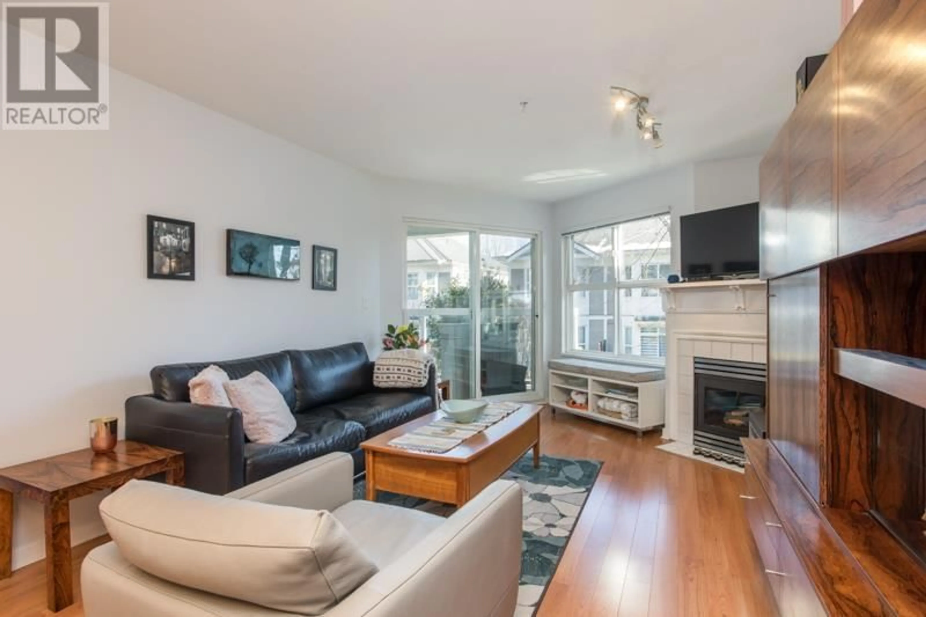 Living room with furniture, wood/laminate floor for 207 3038 E KENT AVENUE SOUTH, Vancouver British Columbia V5S4V8