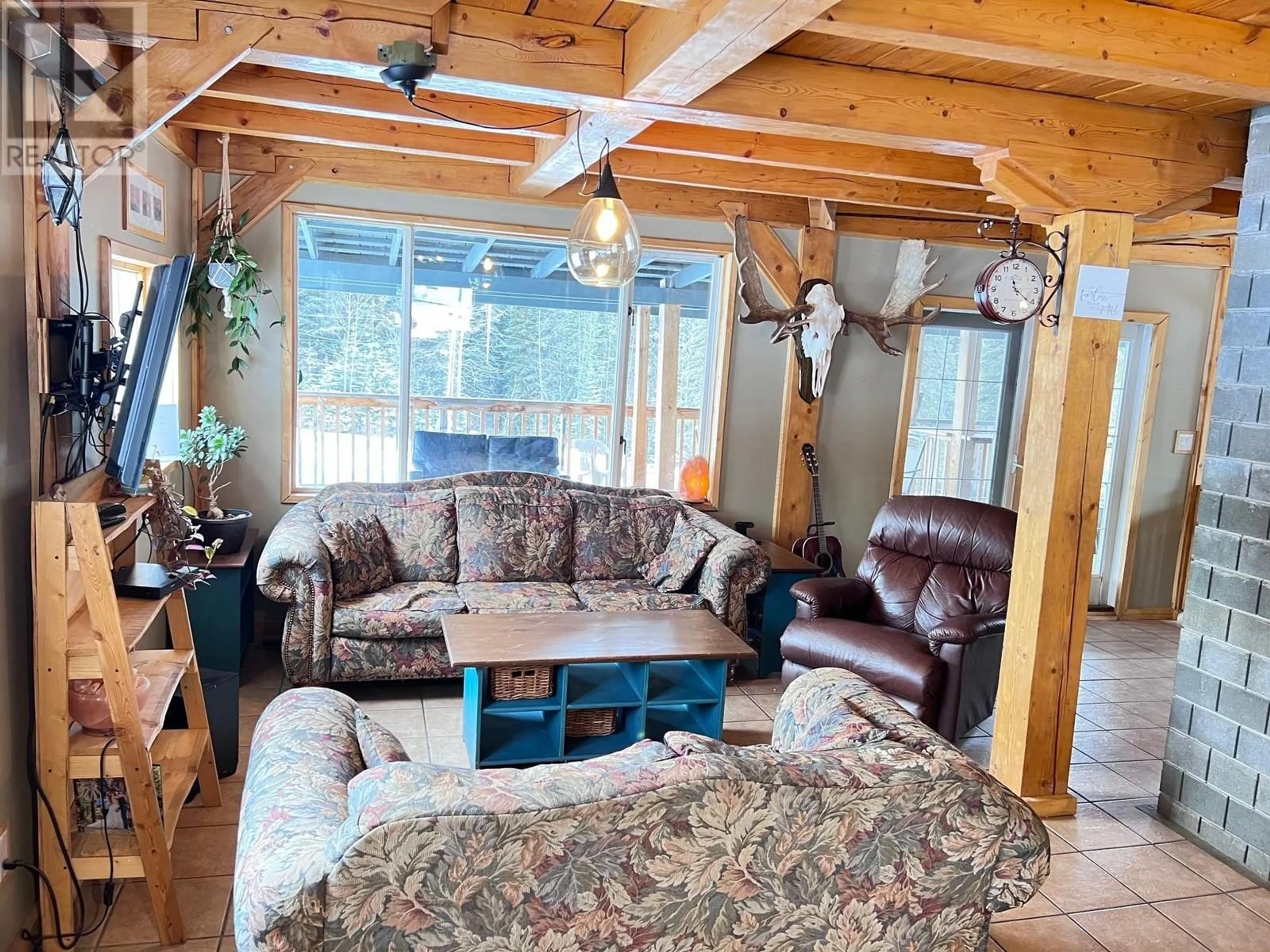 Living room with furniture, wood/laminate floor for 16466 BAGGERMAN ROAD, Houston British Columbia V0J1Z0