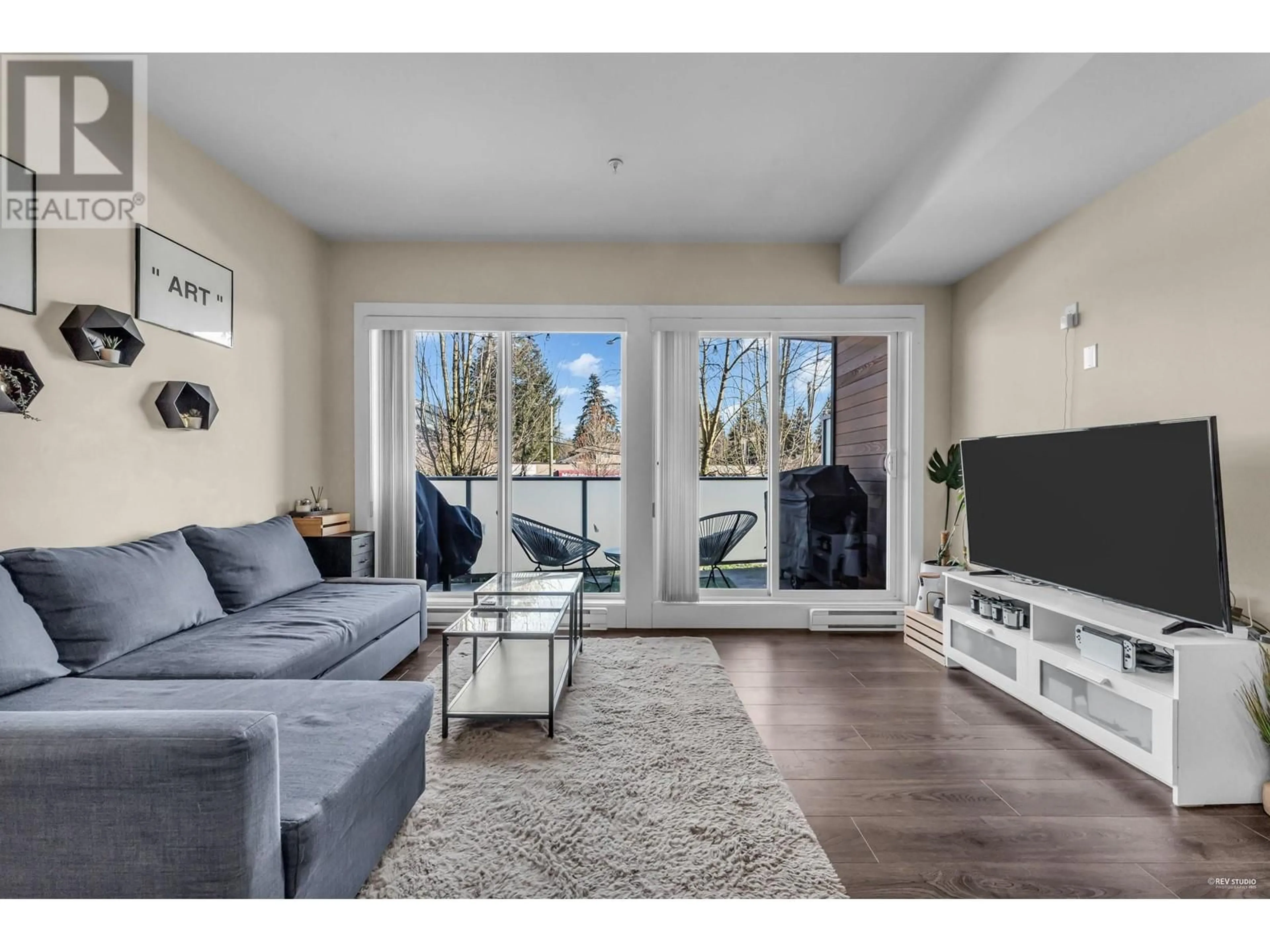 Living room with furniture, wood/laminate floor for 212 7377 14TH AVENUE, Burnaby British Columbia V3N1Z7