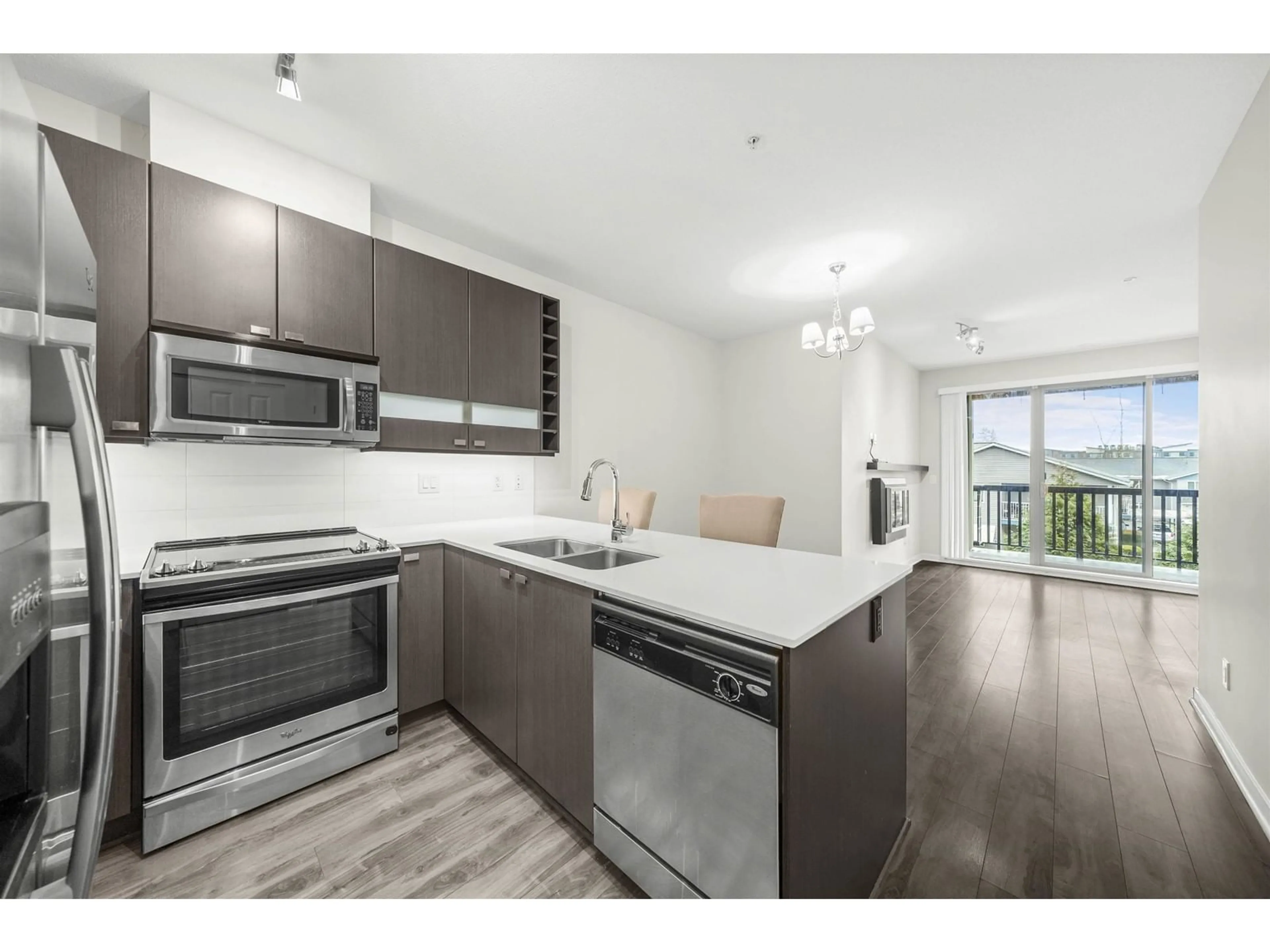 Open concept kitchen, wood/laminate floor for 229 - 5655 210A, Langley British Columbia V3A0G4