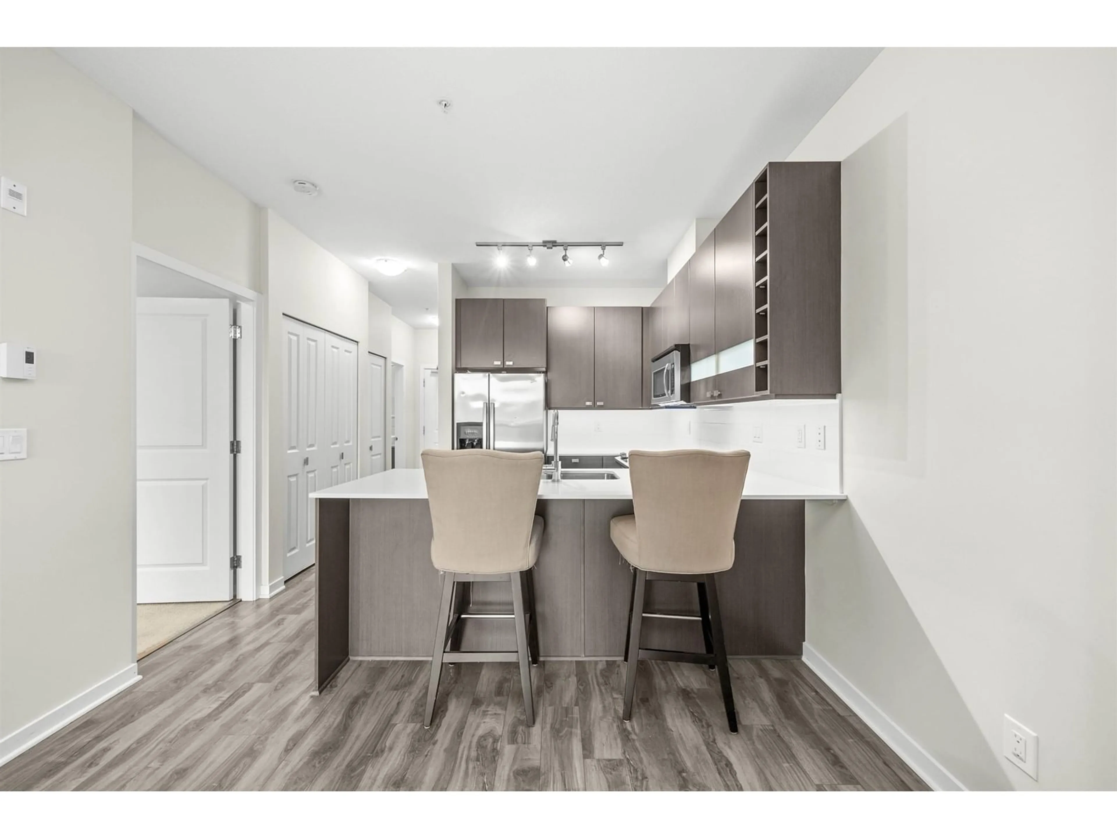 Open concept kitchen, wood/laminate floor for 229 - 5655 210A, Langley British Columbia V3A0G4