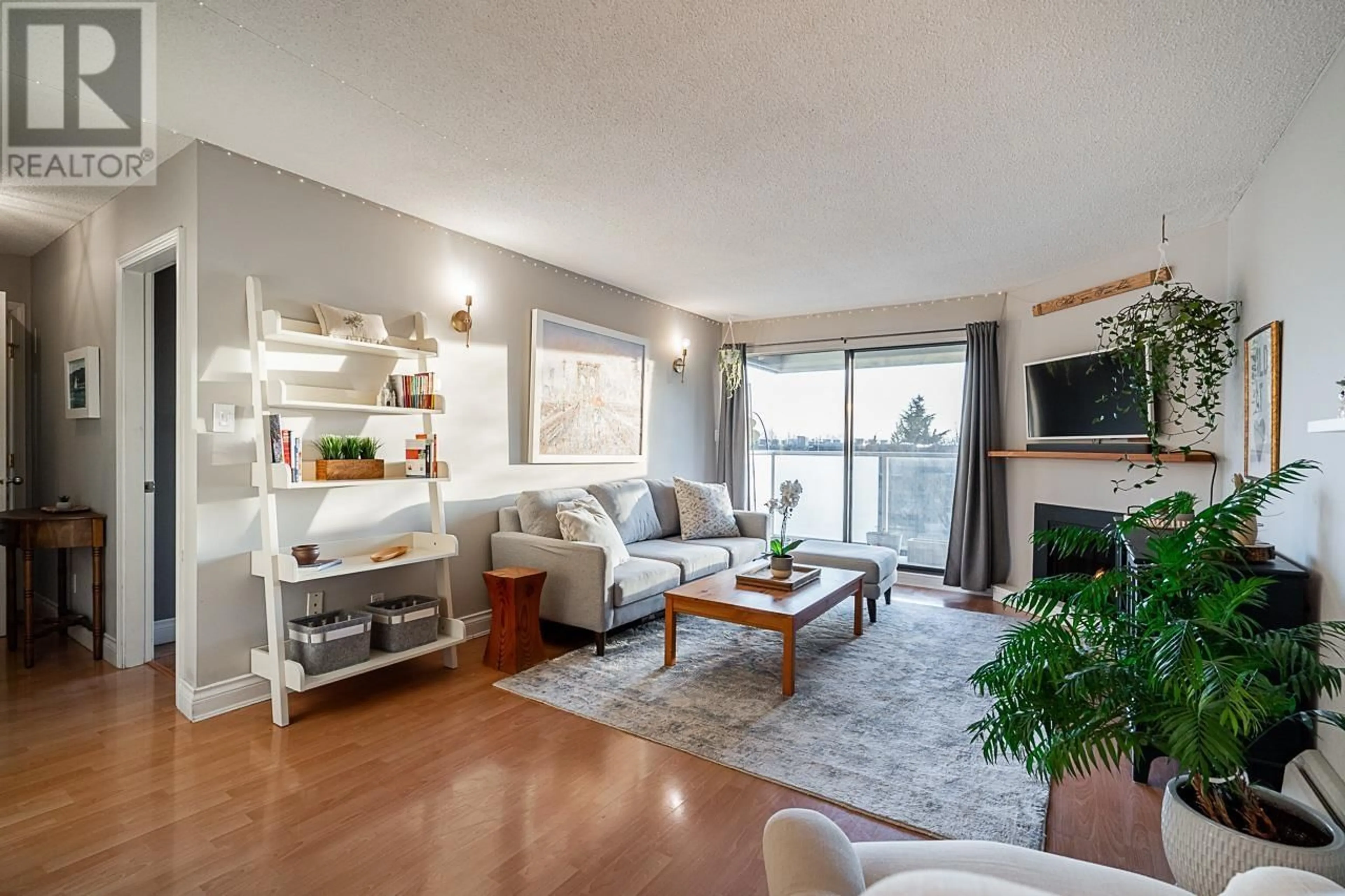 Living room with furniture, wood/laminate floor for 208 308 W 2ND STREET, North Vancouver British Columbia V7M1E1