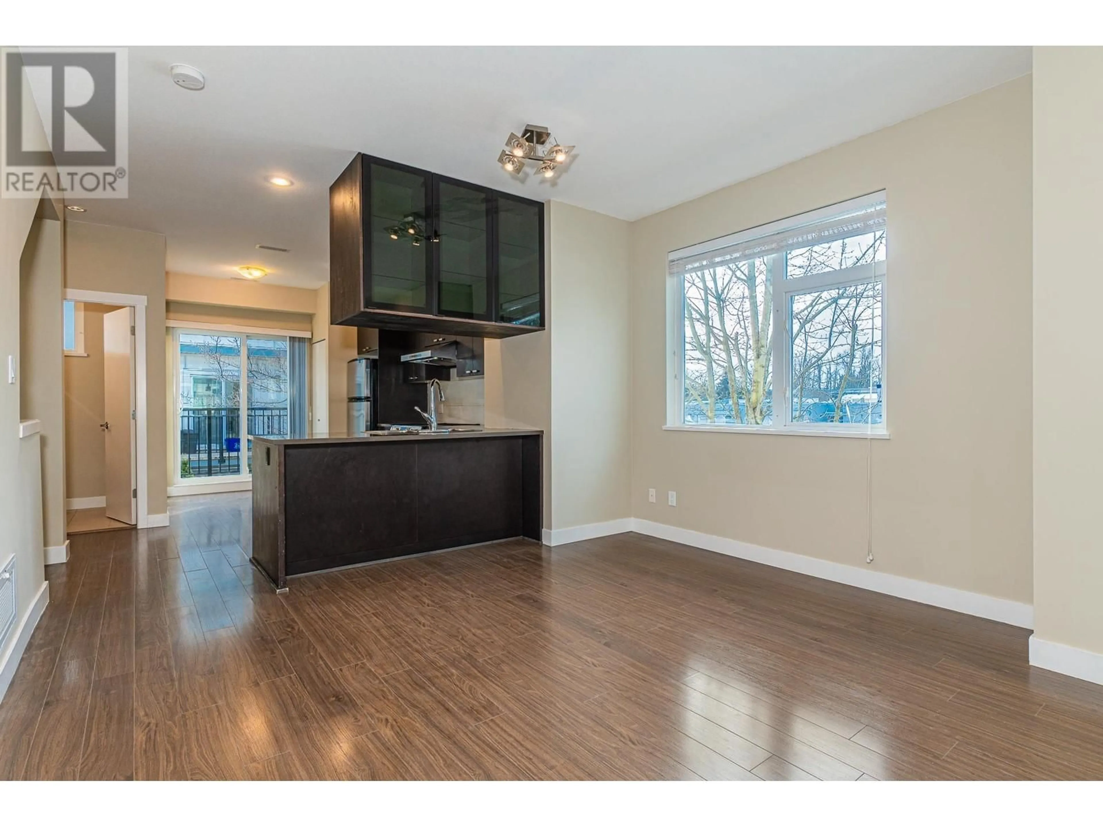 Open concept kitchen, wood/laminate floor for 23 4099 NO. 4 ROAD, Richmond British Columbia V6X2M2